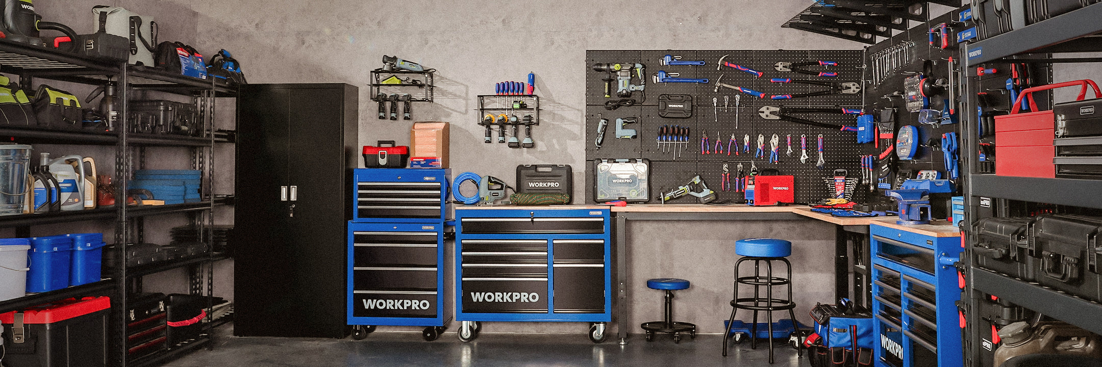 Workshop tool bench with blue cabinets, pegboard tools, and shelves of supplies in a garage