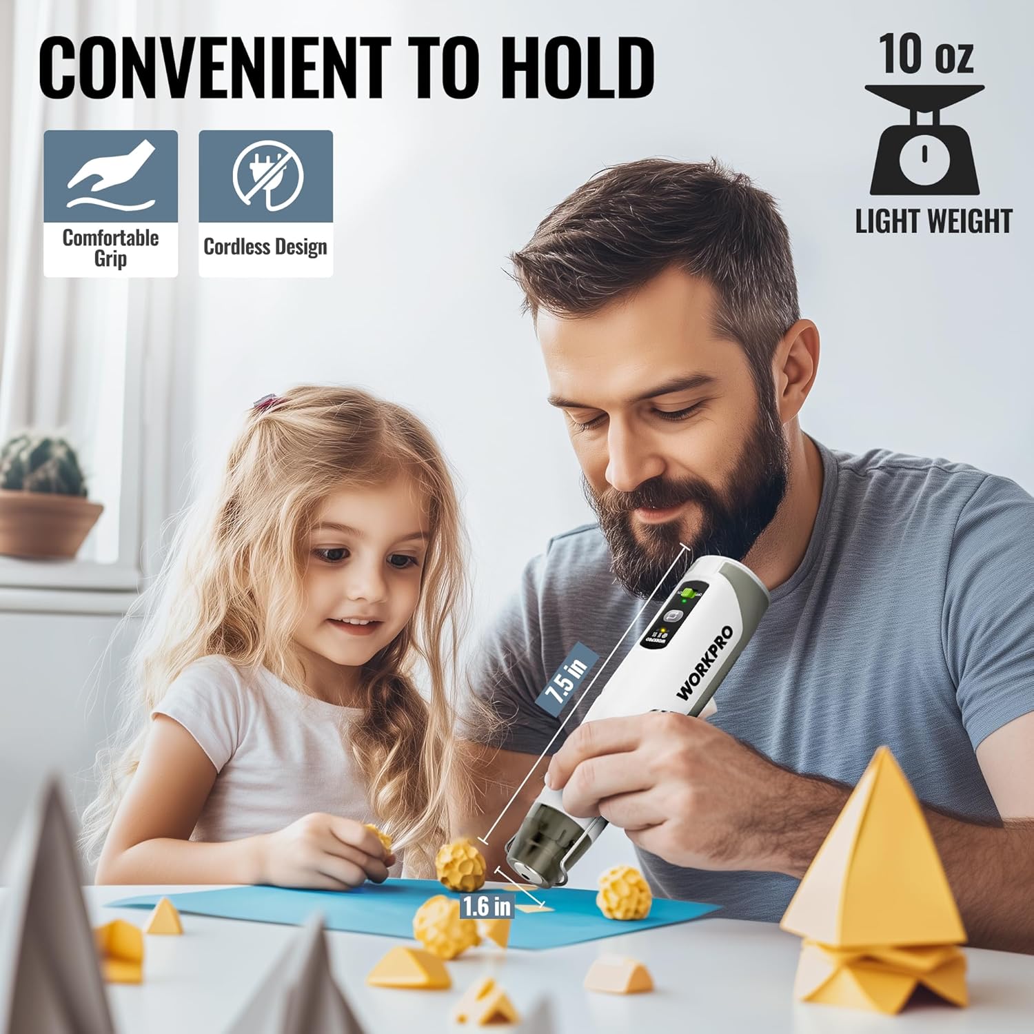 Cordless mini heat gun with metal nozzle, held in hand for DIY crafting work.