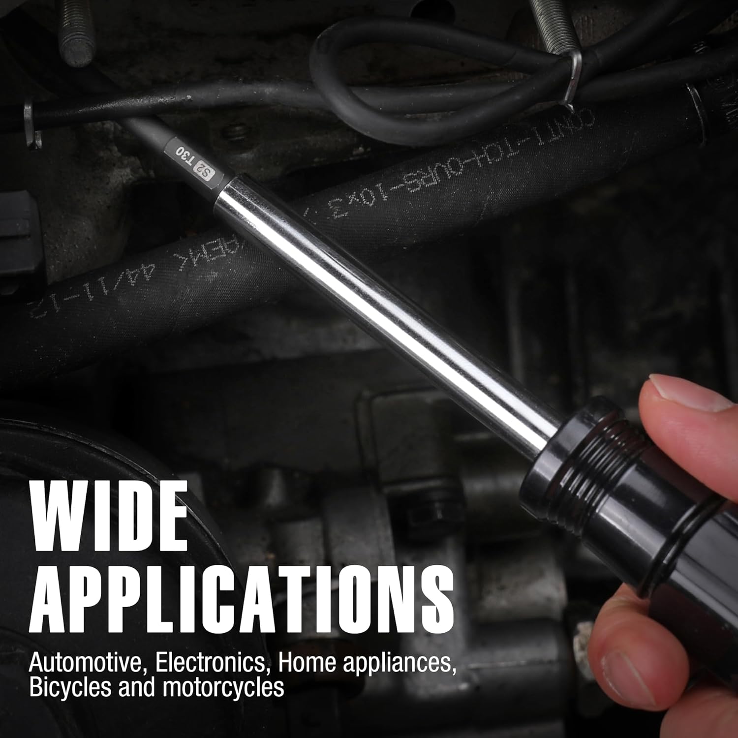 Torx bit with magnetic tip being held over power tools and wiring