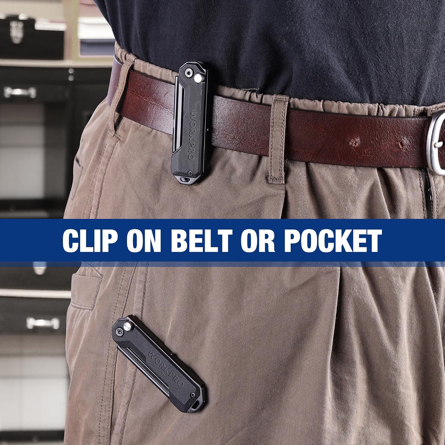 Black pocket utility knife clipped to a belt loop on work pants