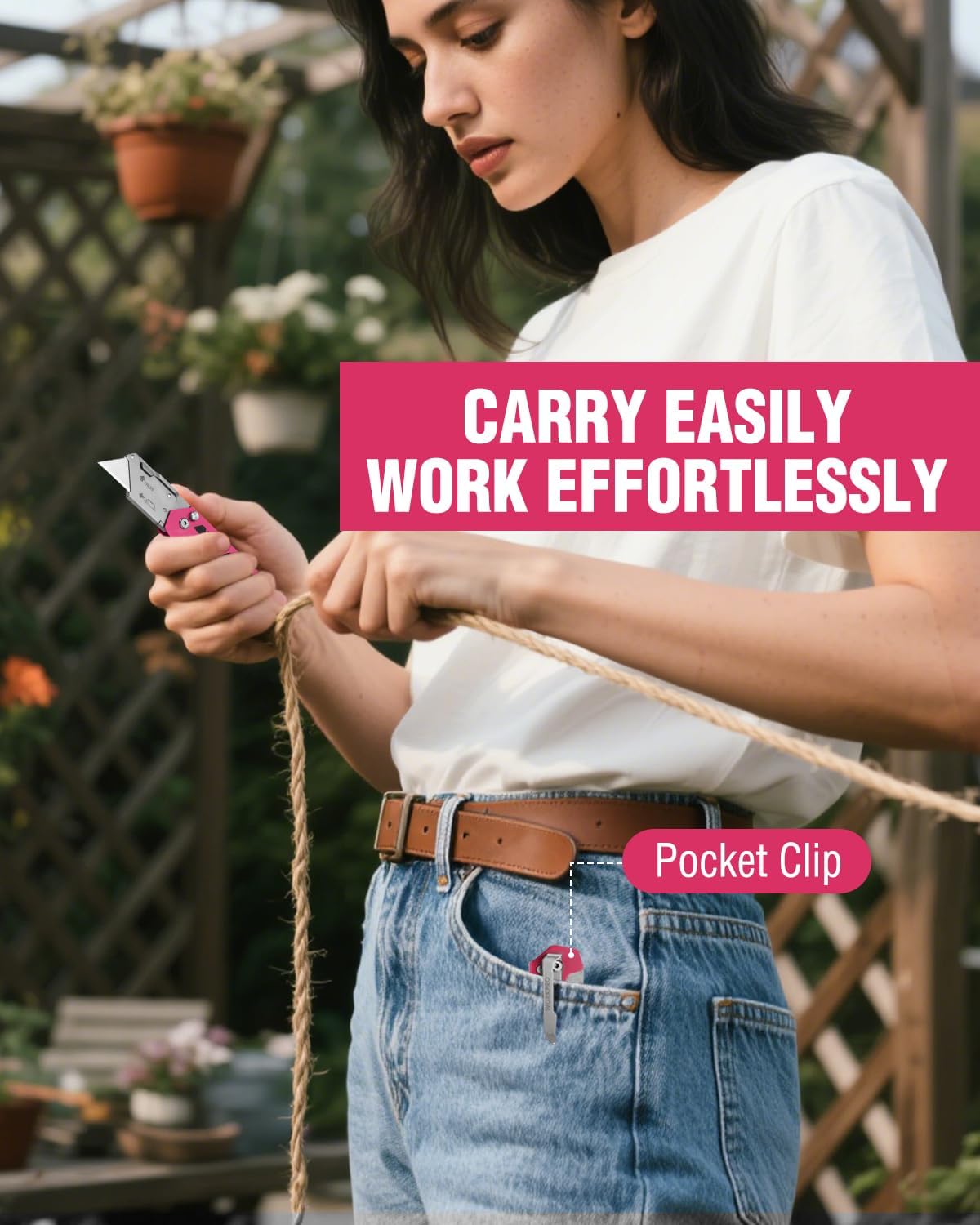 Pink folding utility knife with pocket clip, held in hand