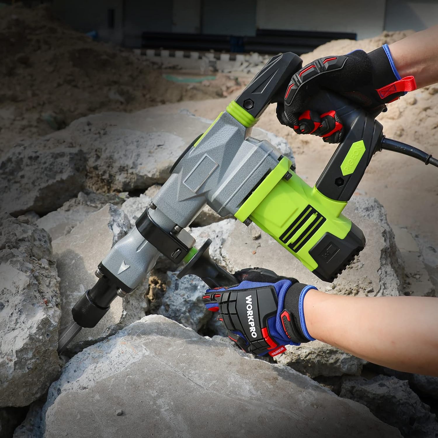 Work gloves worn on hands gripping tools, showing black-and-blue impact knuckle padding.