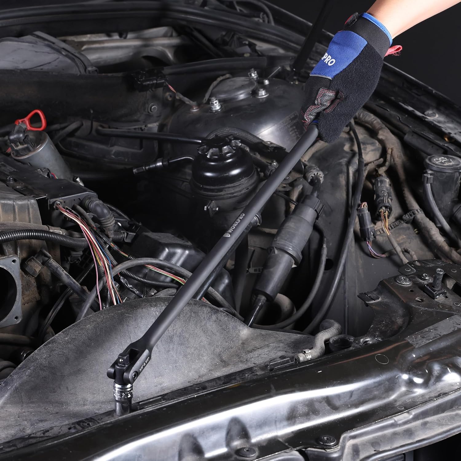 Breaker bar used in an engine bay with long black shaft and socket end