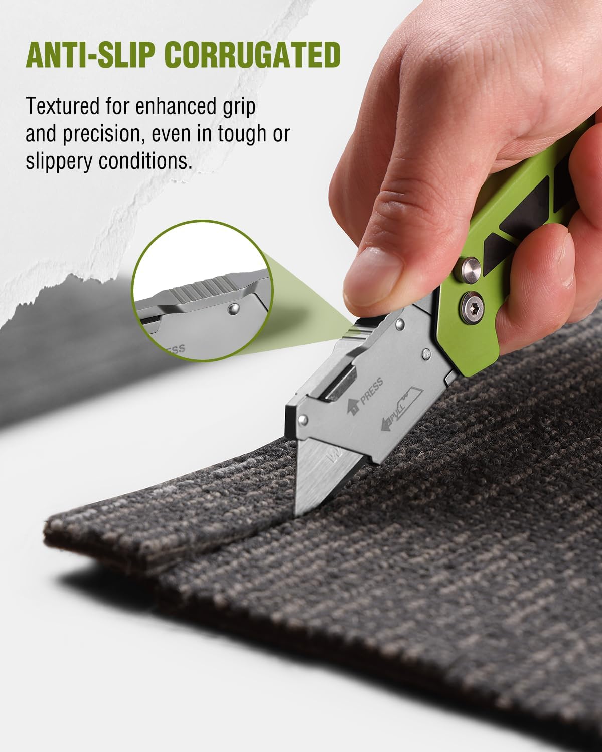 Green utility knife with textured grip; blade deployed to cut fabric edge