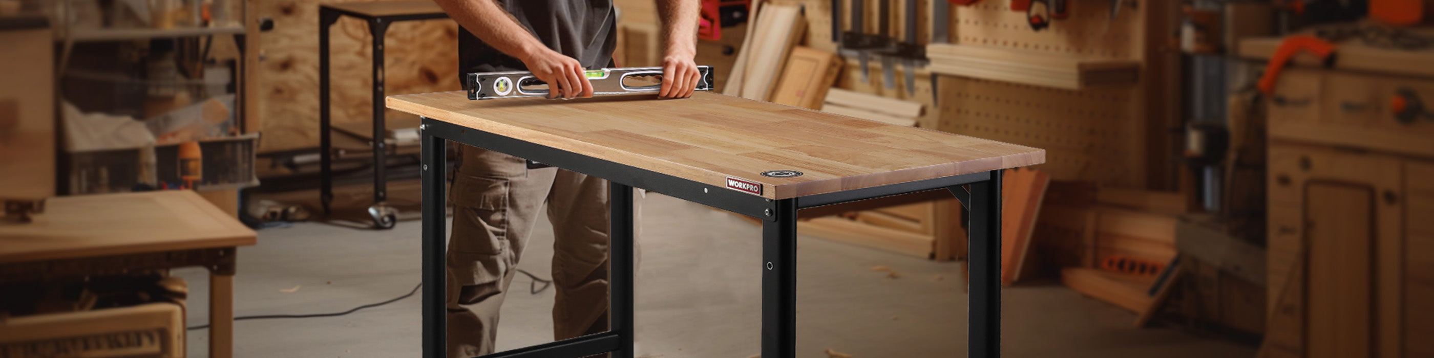 Woodwork bench in a workshop with a person using a level, showing innovation and quality in durable tools