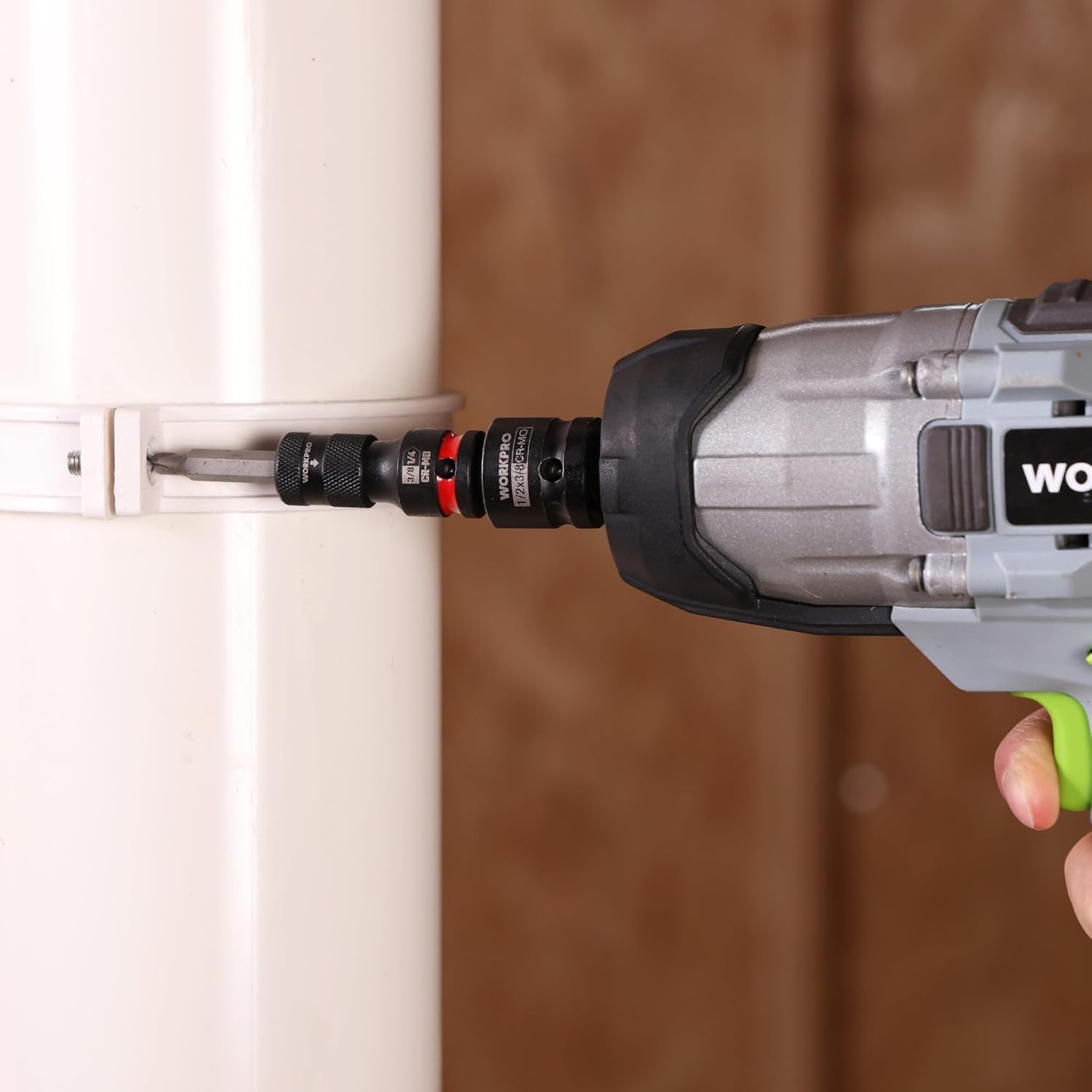 Impact socket adapter attached to a power tool, black knurled grip with red ring