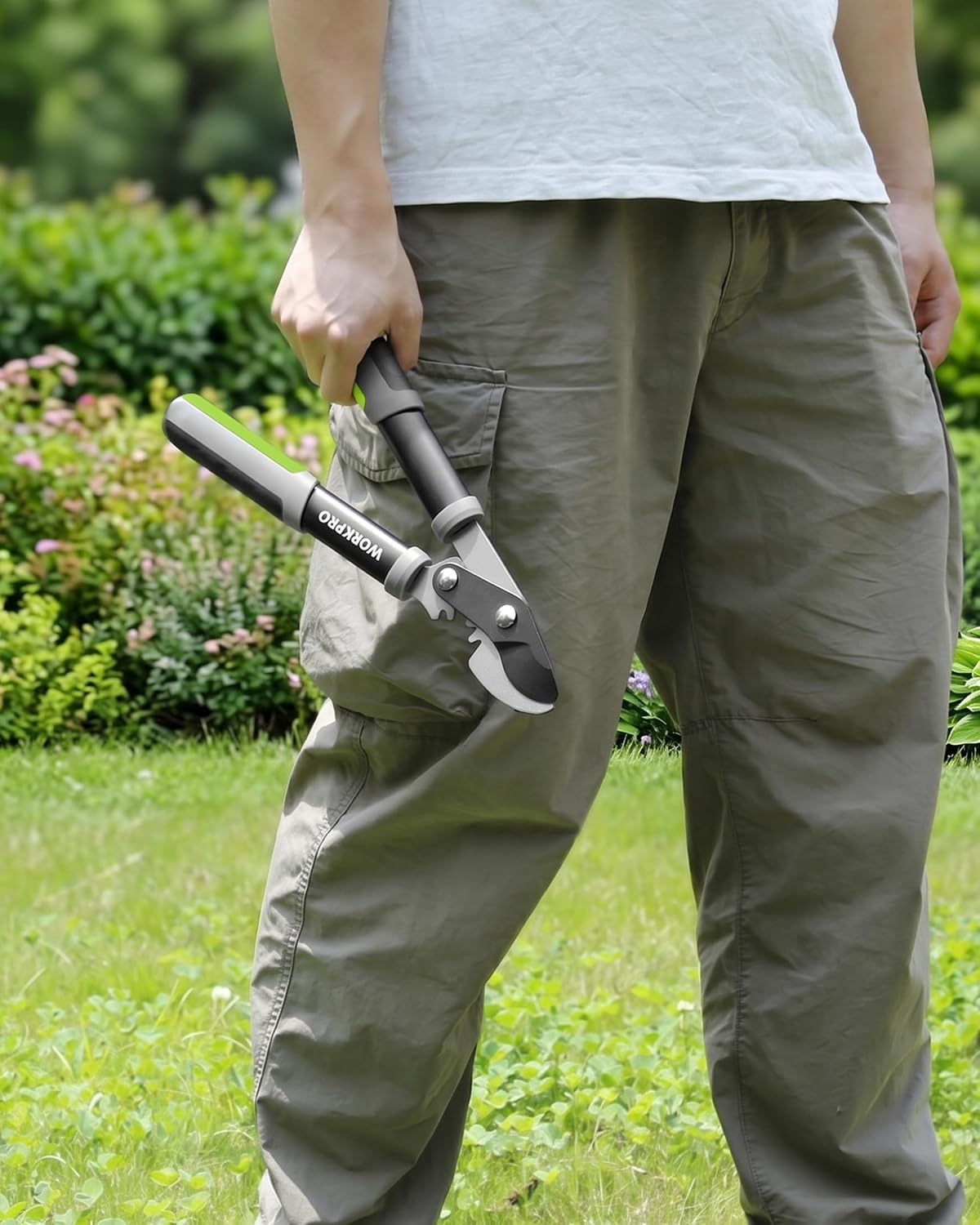 Bypass lopper held in use on garden plants with long handles