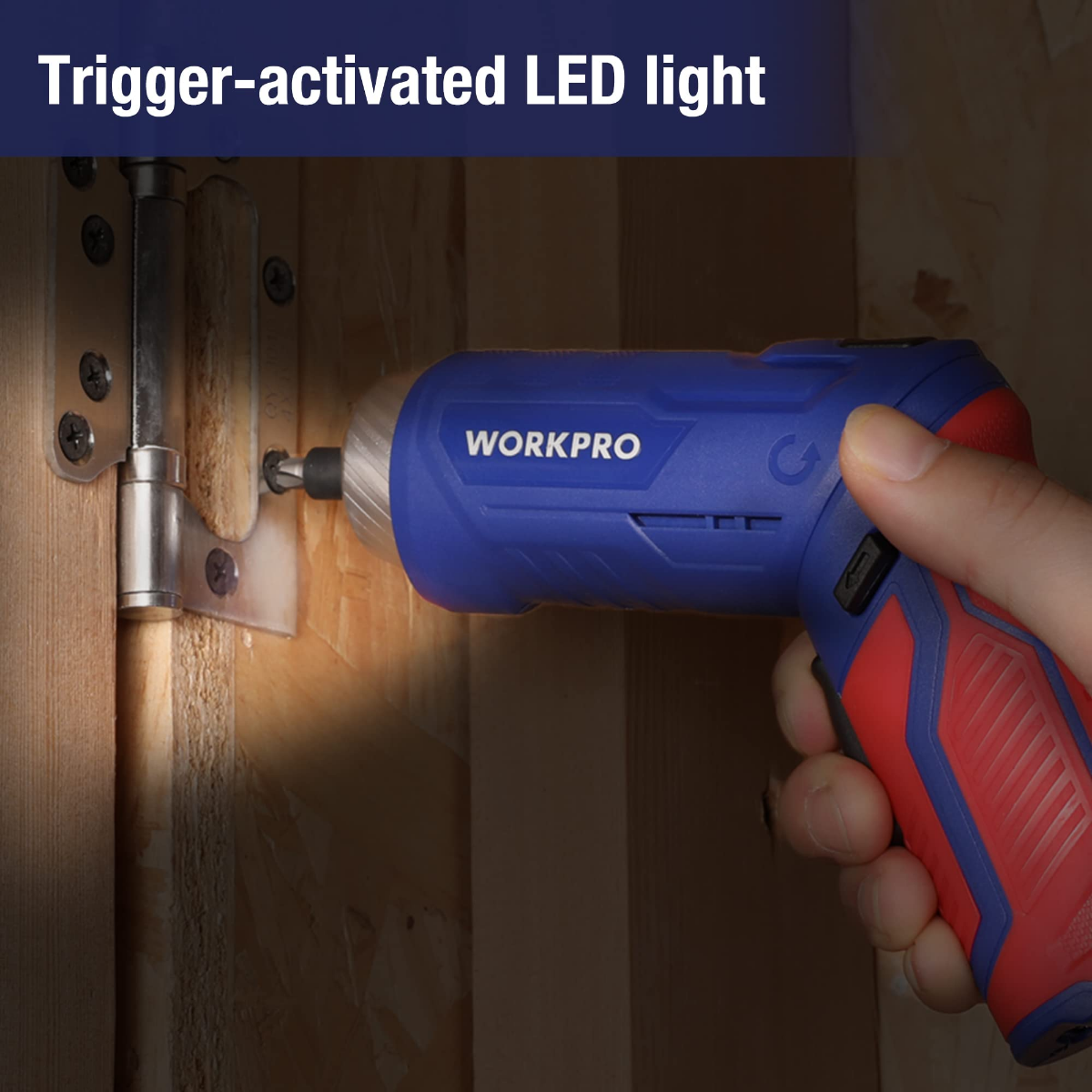 Blue cordless drill with trigger-activated light held near a wooden door hinge