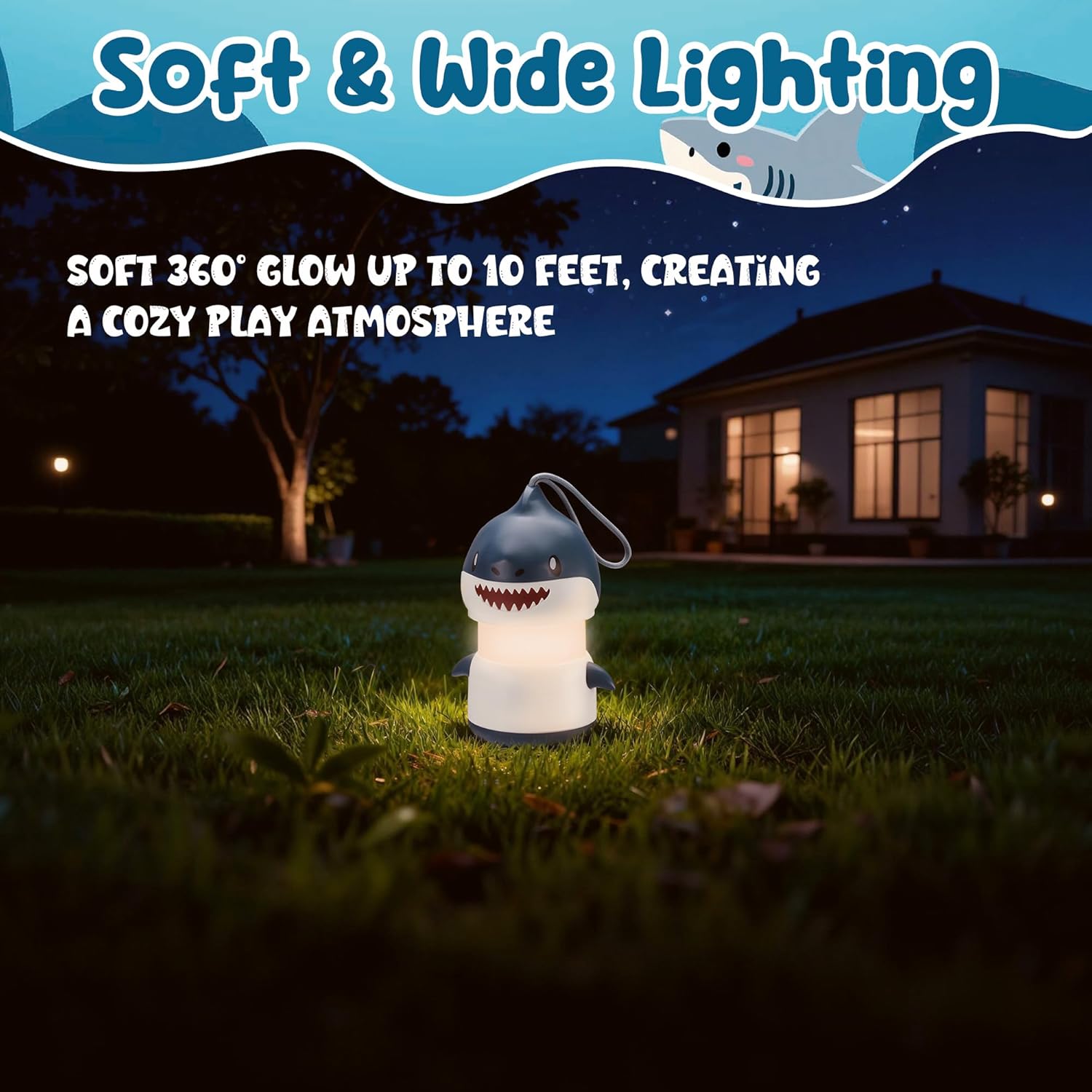 Small blue shark camping lantern with white base on grass, soft warm glow