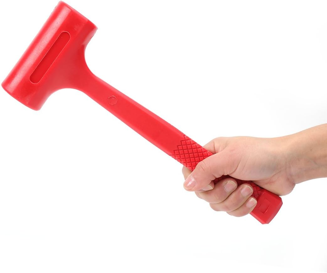 Red dead blow hammer held in hand, showing ribbed grip and ergonomic handle