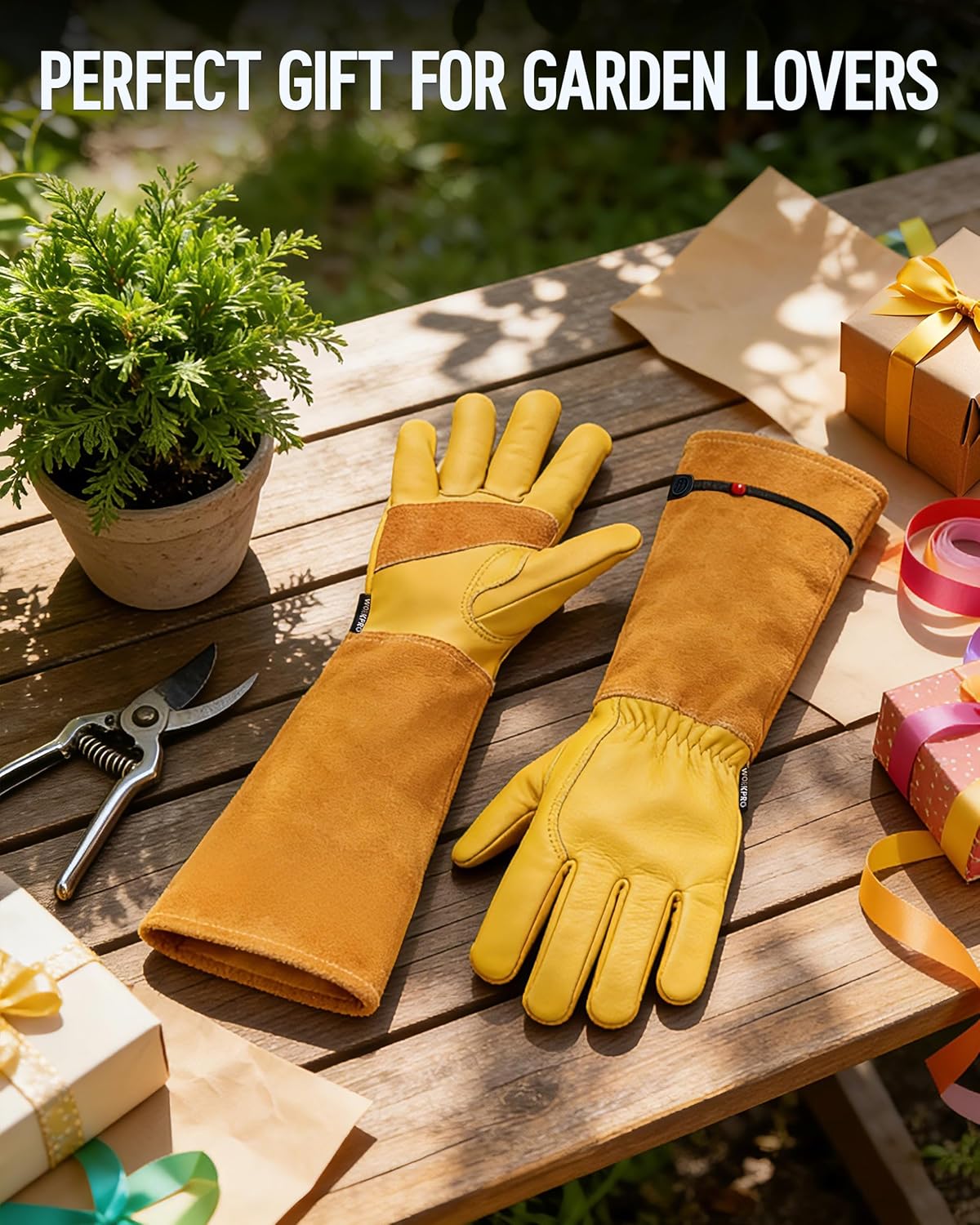 Long yellow leather gardening gloves with black wrist strap laid on a wooden table with gifts