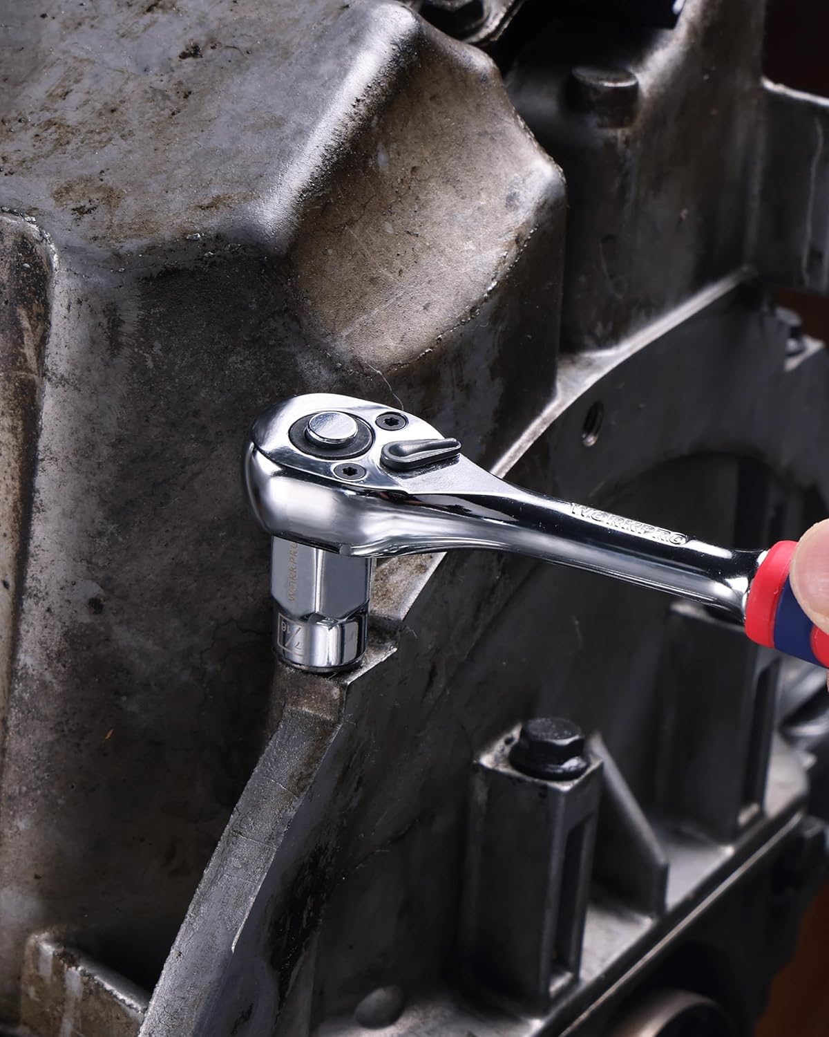 3/8-in drive socket engaged on a metal fastener with a ratchet wrench