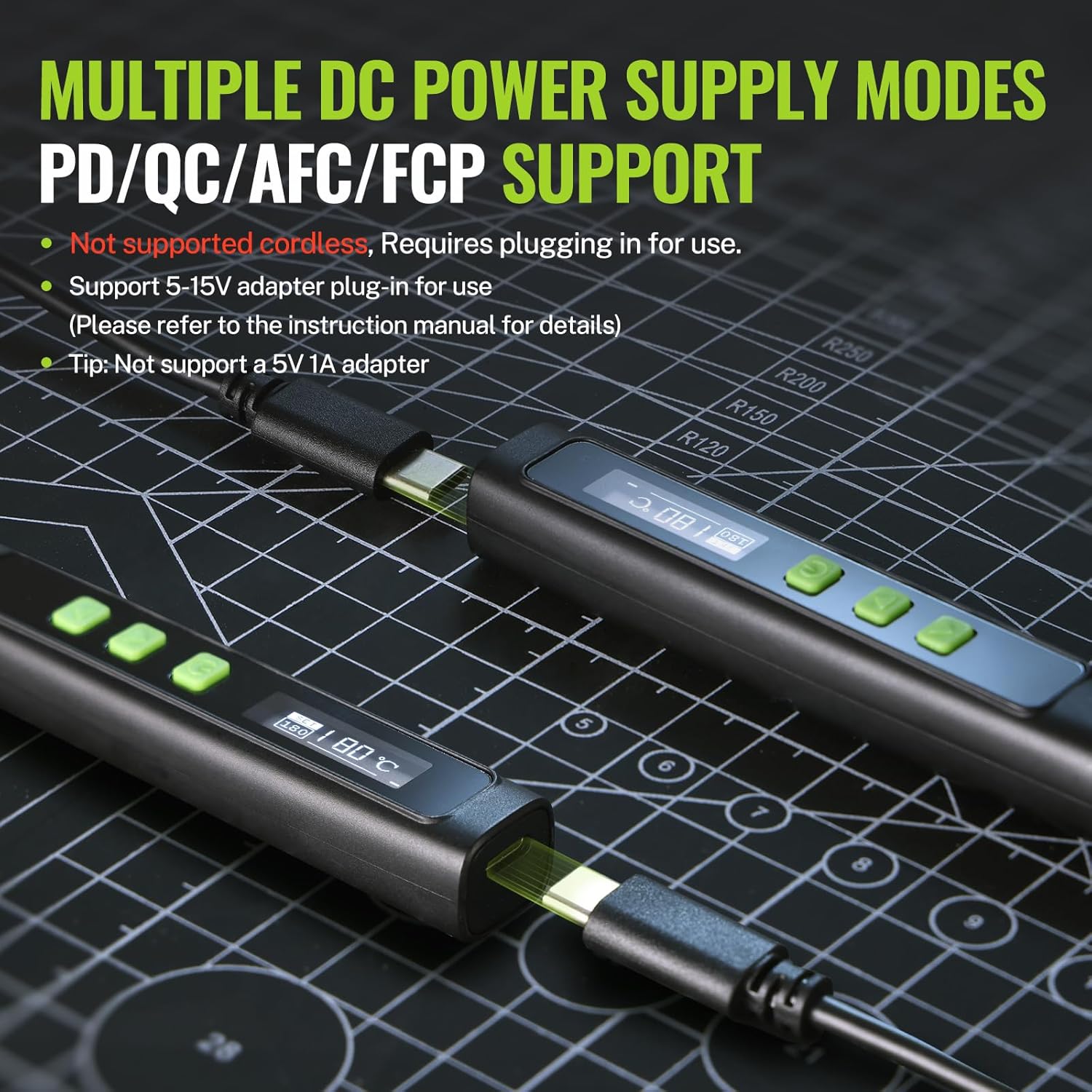 Soldering iron kit with two black pen handles, green accents, and multiple tips