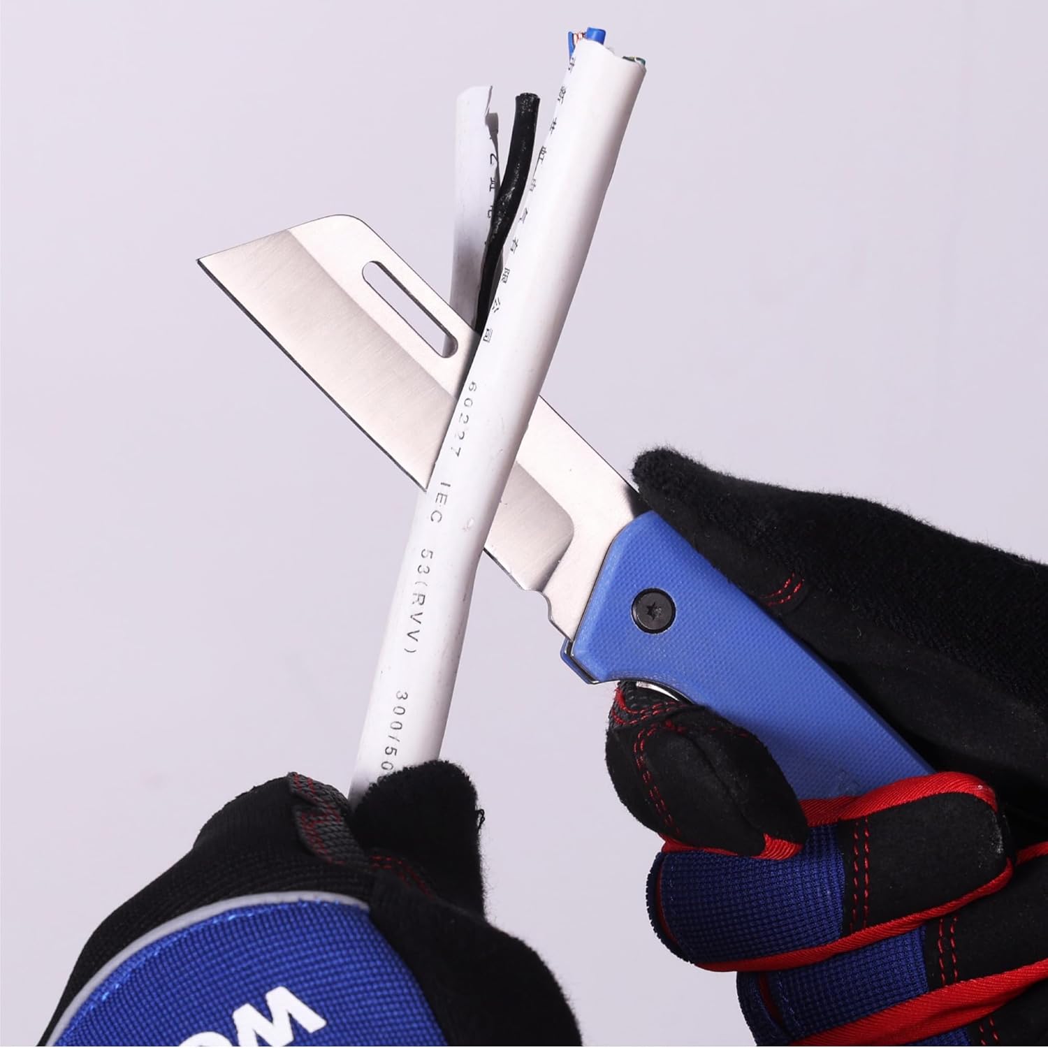 Blue folding utility knife held by a black-red glove, stainless blade extended