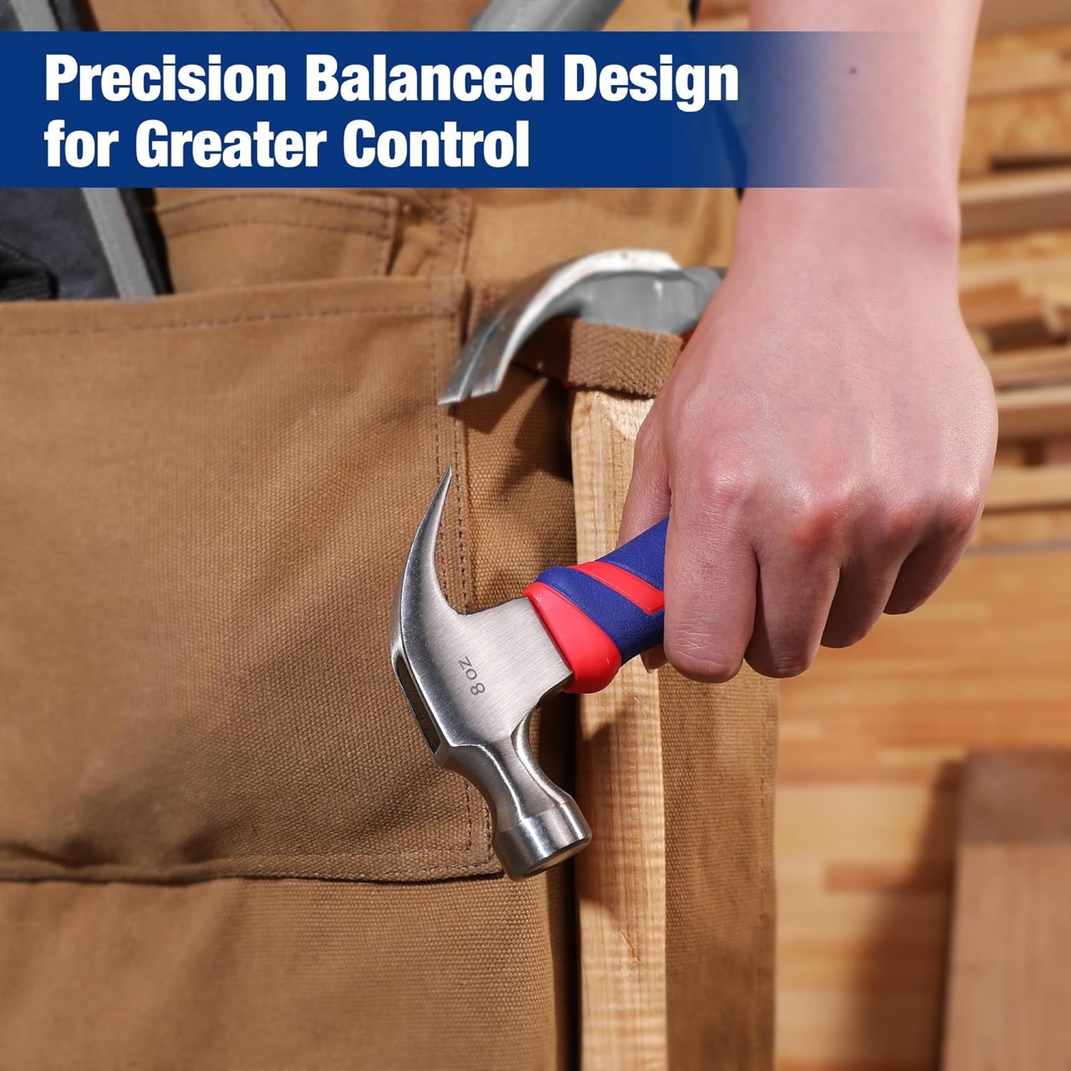Claw hammer pulling a nail from wood, steel claw head and blue-red fiberglass handle
