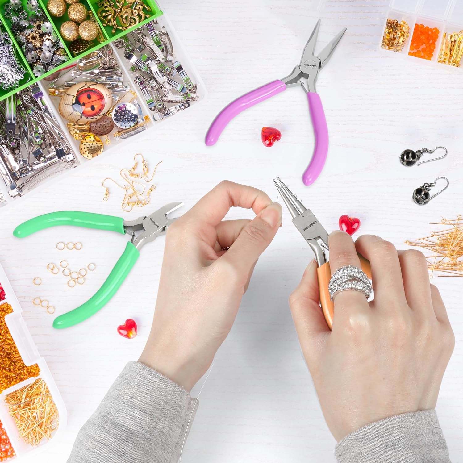 Mini jewelry pliers set on jewelry craft supplies with green and purple pliers