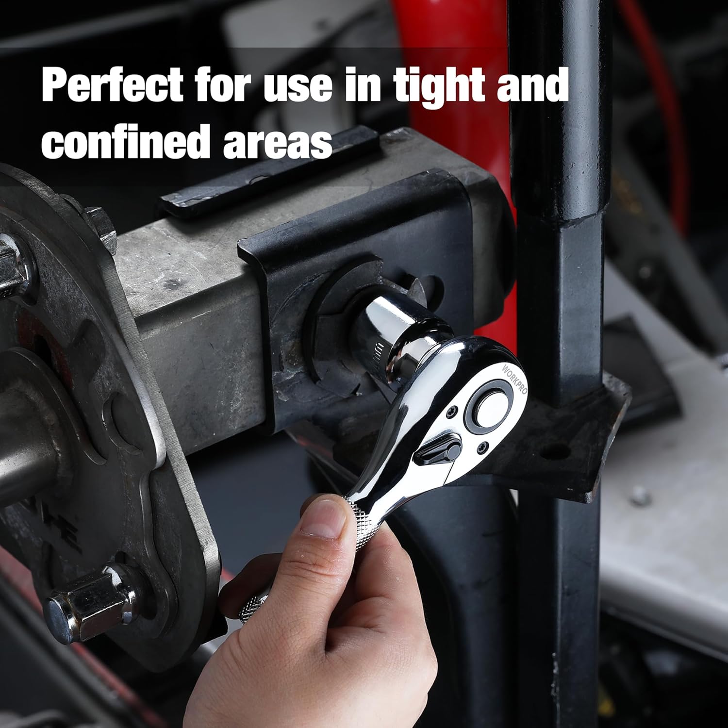 Chrome stubby ratchet in use at tight angle, with knurled grip and reversible head