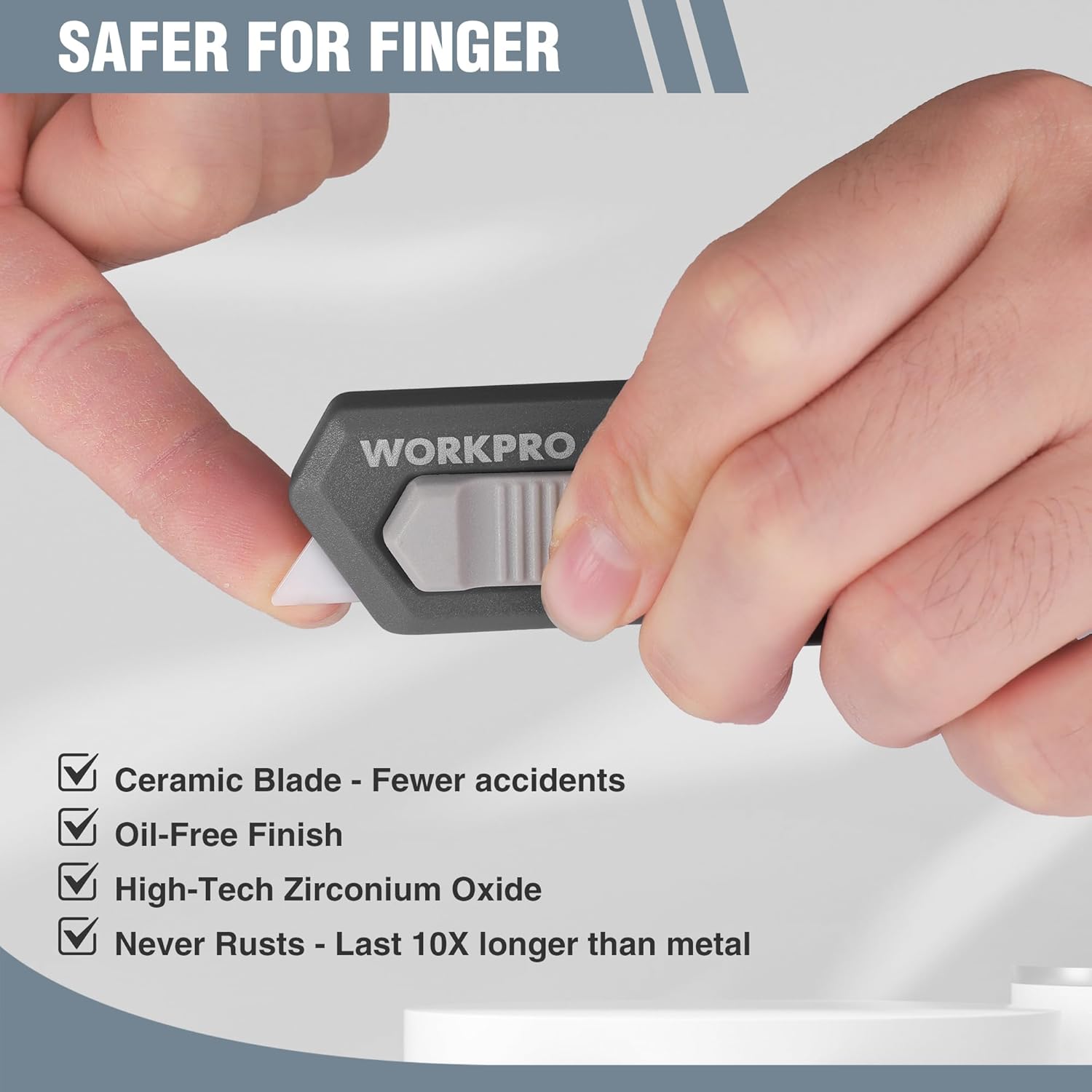 WORKPRO ceramic safety box cutter with retractable mini blade, held in hand