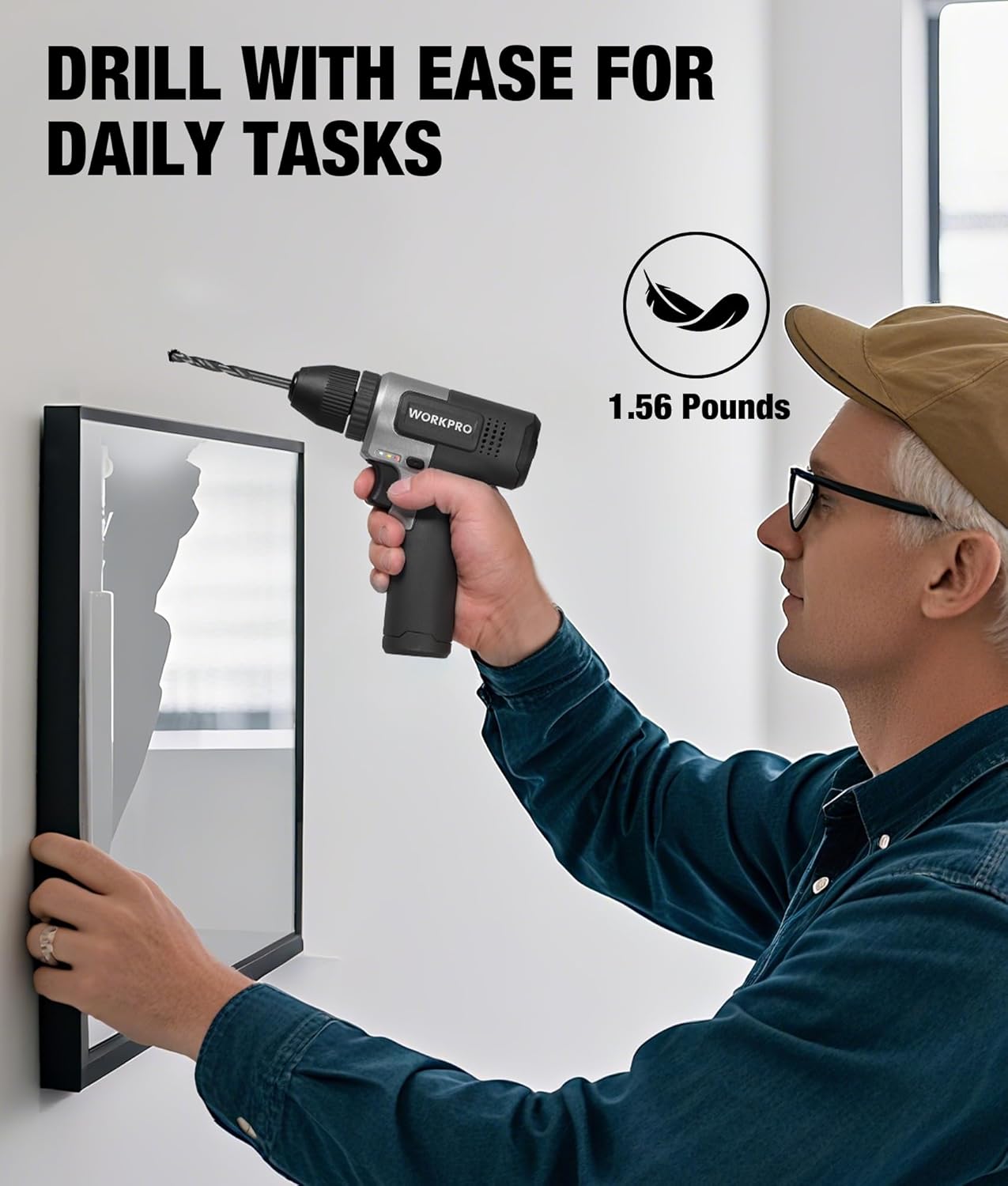 Cordless drill with keyless chuck in black, hand-held while drilling a wall panel