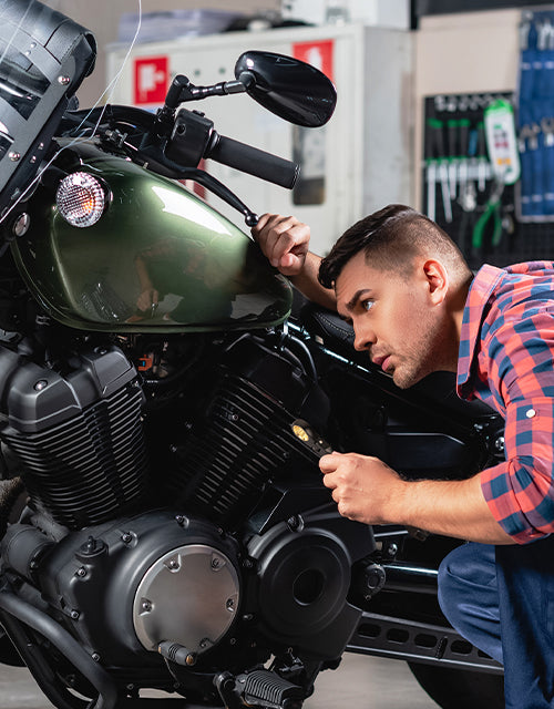 Mechanic inspects motorcycle engine with careful innovation and visible quality, secure fasteners, and durable metal parts