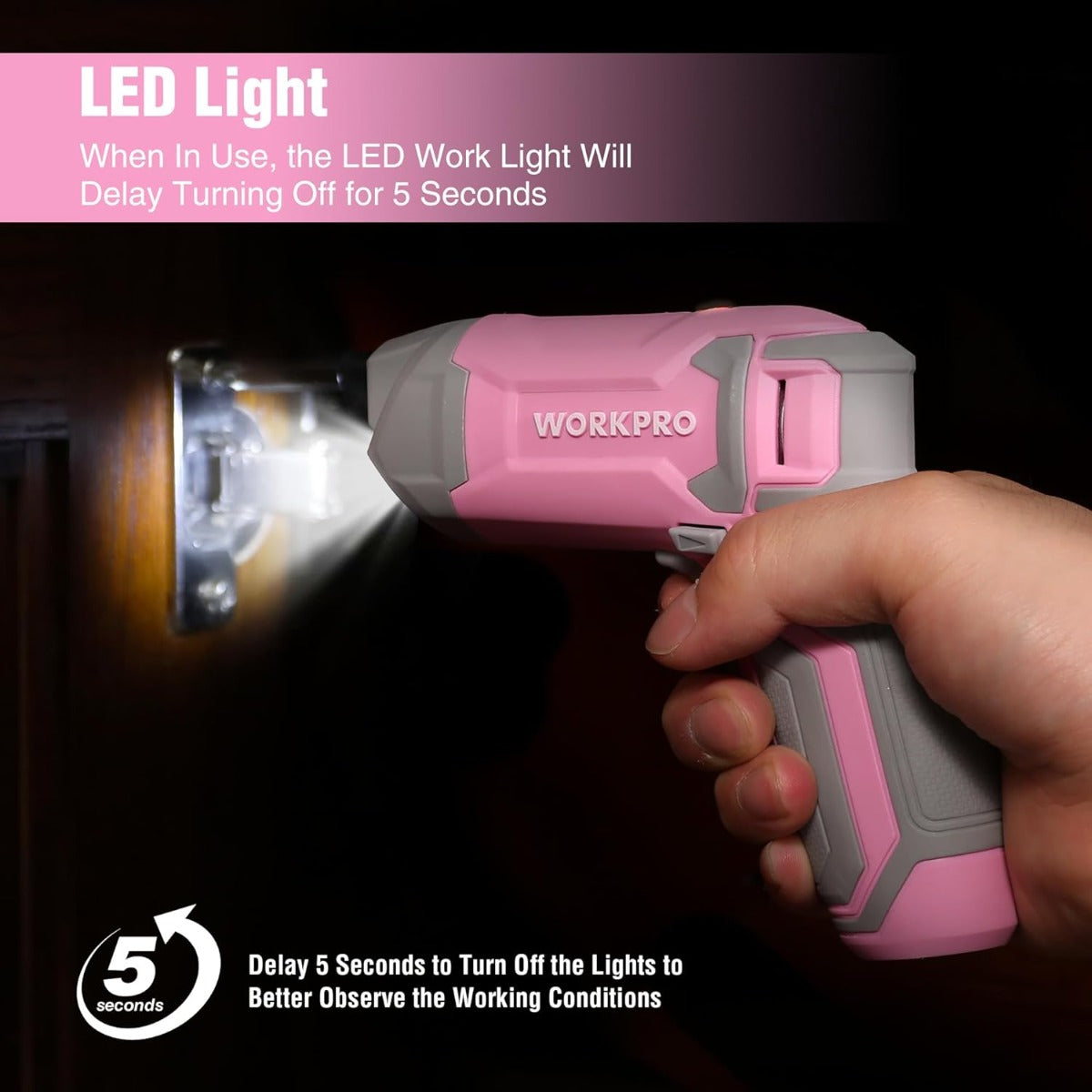 Pink cordless screwdriver with LED work light shining on a screw head