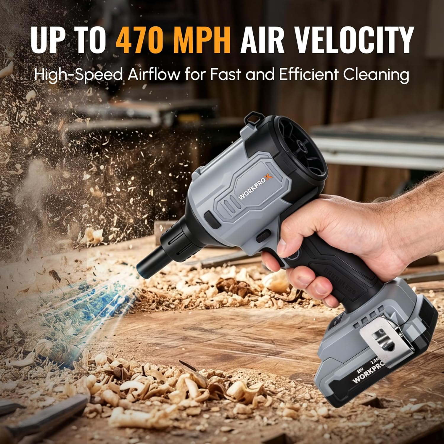 Handheld air duster blower releasing dust and debris, black and gray housing