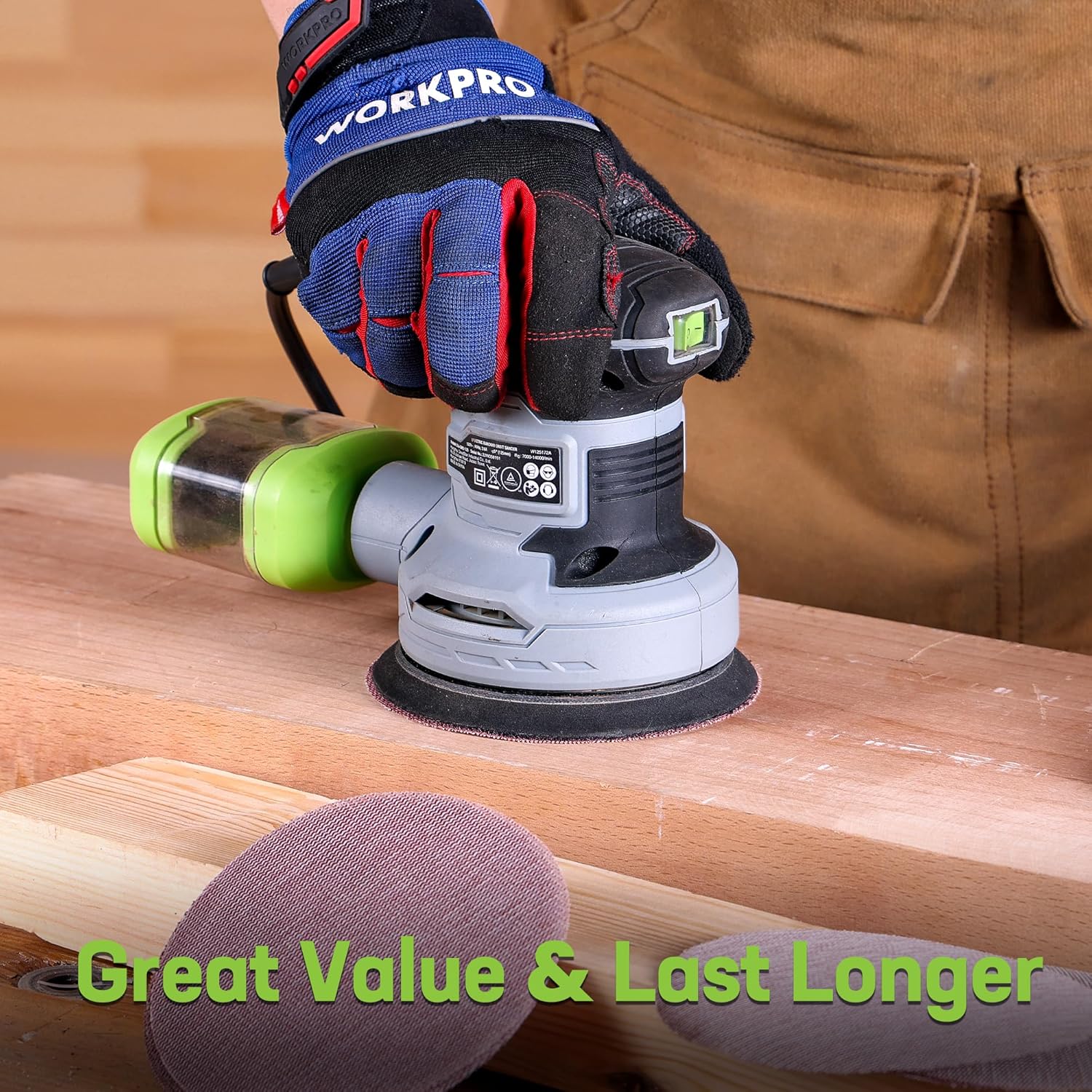 Orbital sander sanding a wooden surface with a purple-brown sanding disc