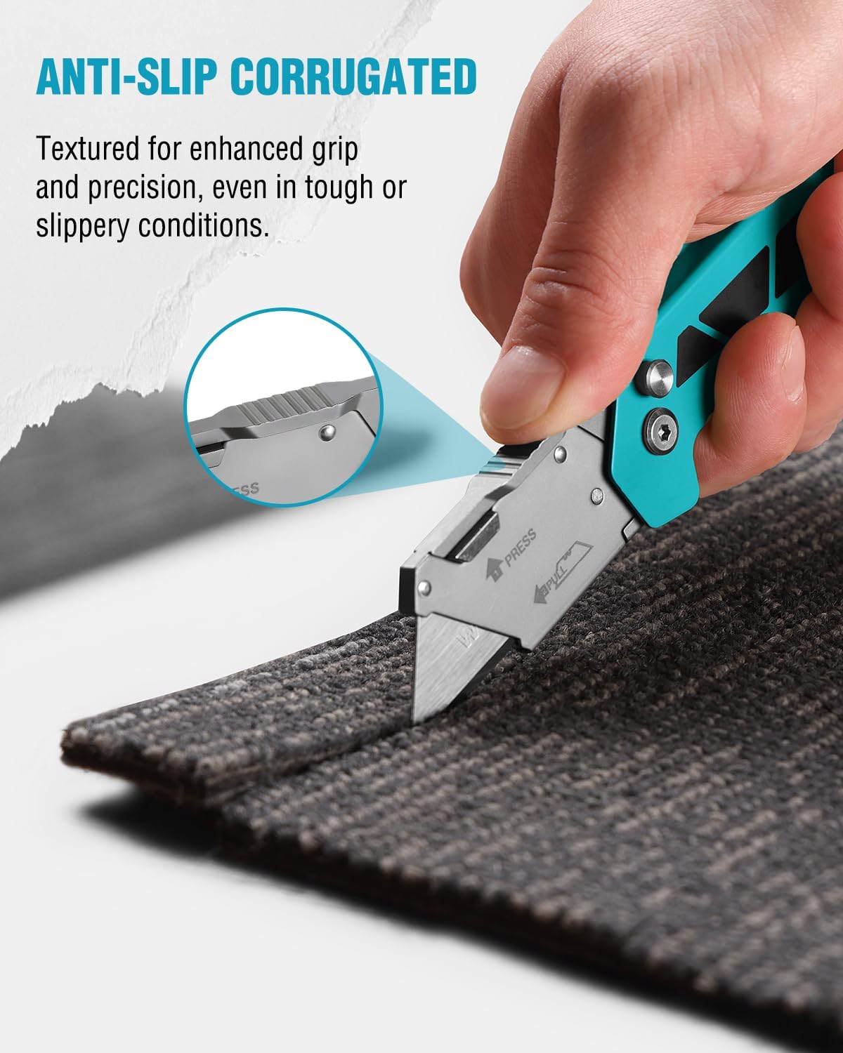 Folding utility knife with teal handle, textured grip, cutting a fabric surface