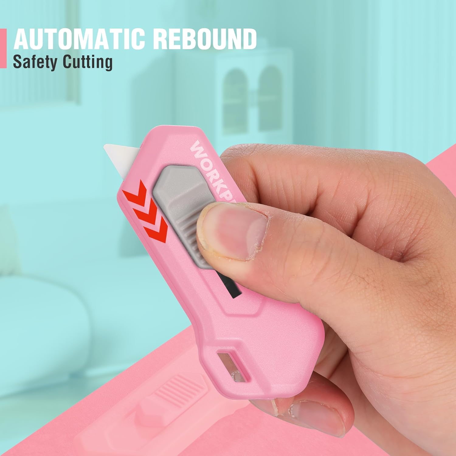 Pink automatic rebound safety box cutter held in hand with blade extended