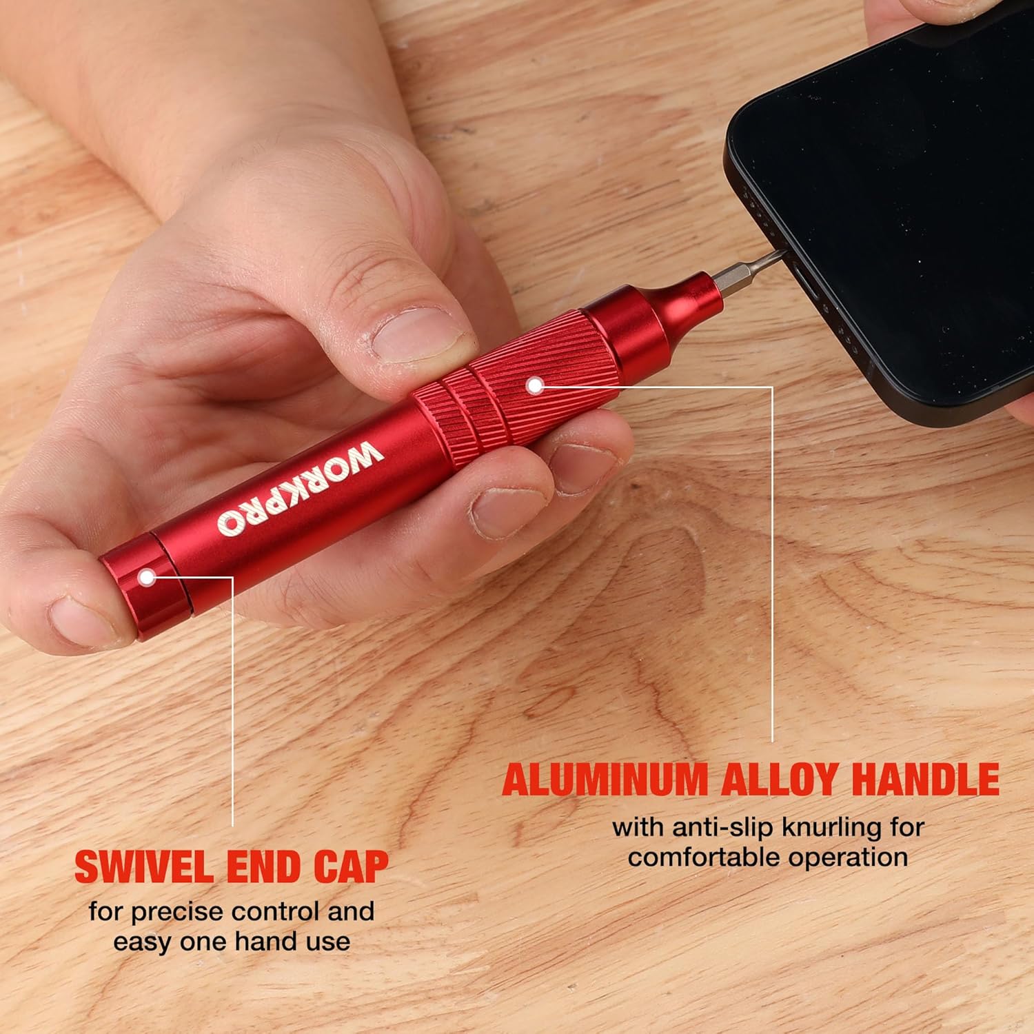 Red mini screwdriver with swivel end cap and aluminum alloy handle on wood