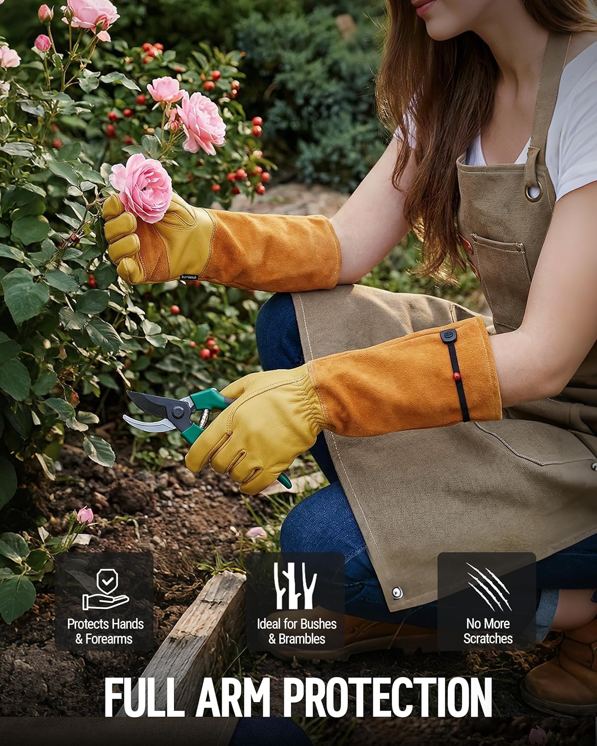 Long leather gardening gloves in yellow with black wrist strap, worn while pruning flowers
