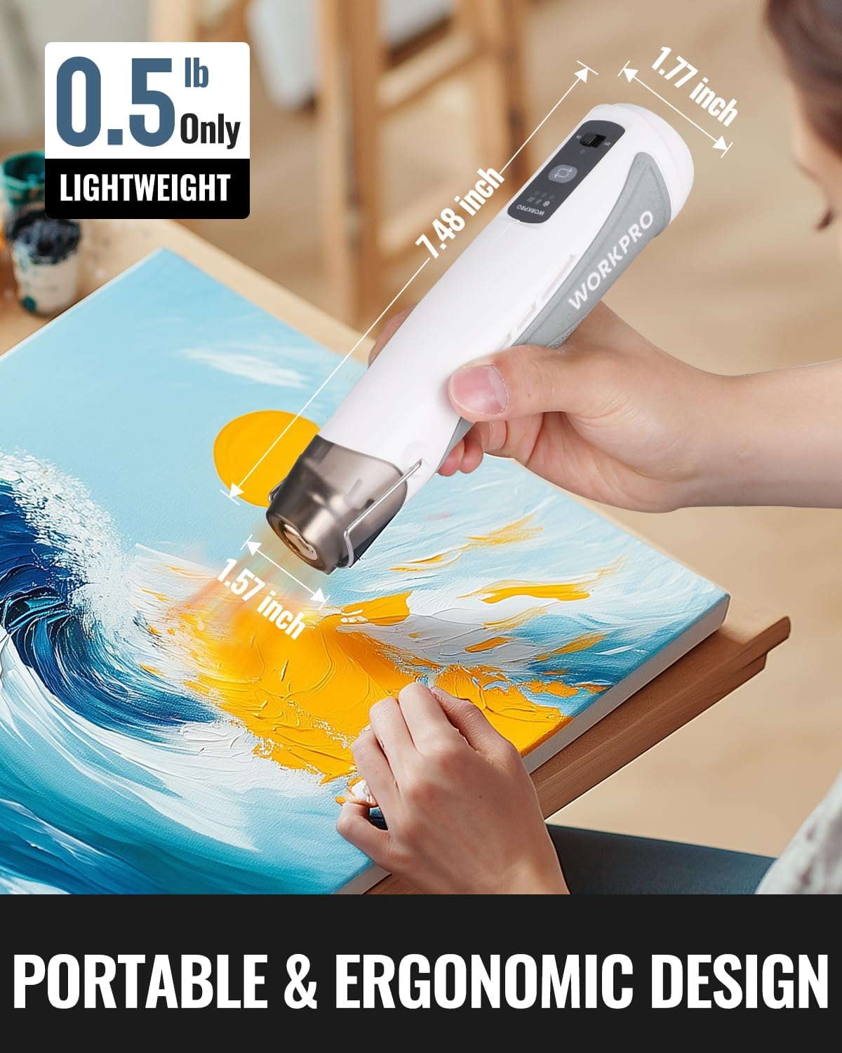Lightweight mini cordless heat gun applying hot air to artwork, white and silver