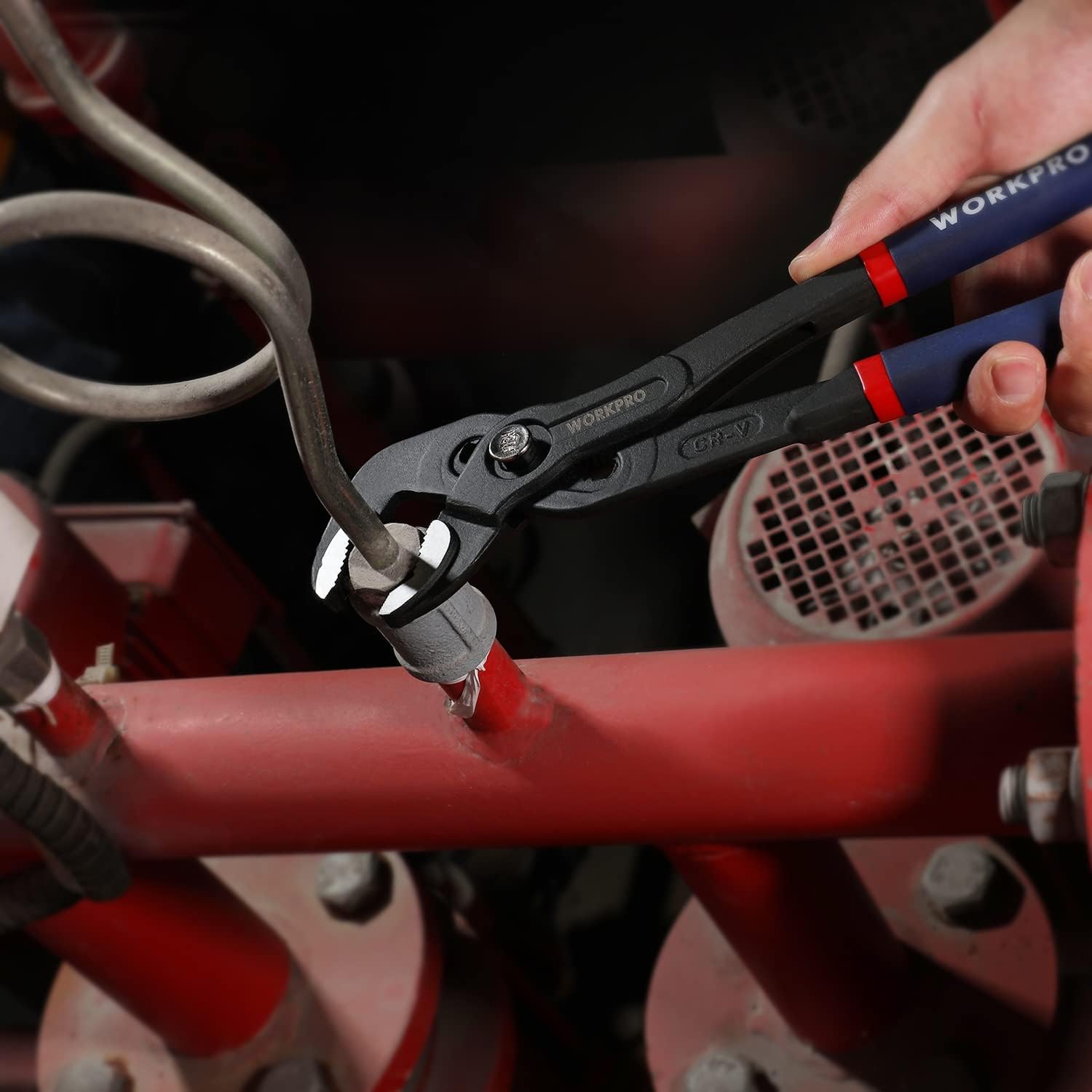 Hand turning a pipe fitting using V-jaw groove joint pliers with blue handle grips