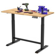 Standing height adjustable workbench with light wood tabletop and black frame