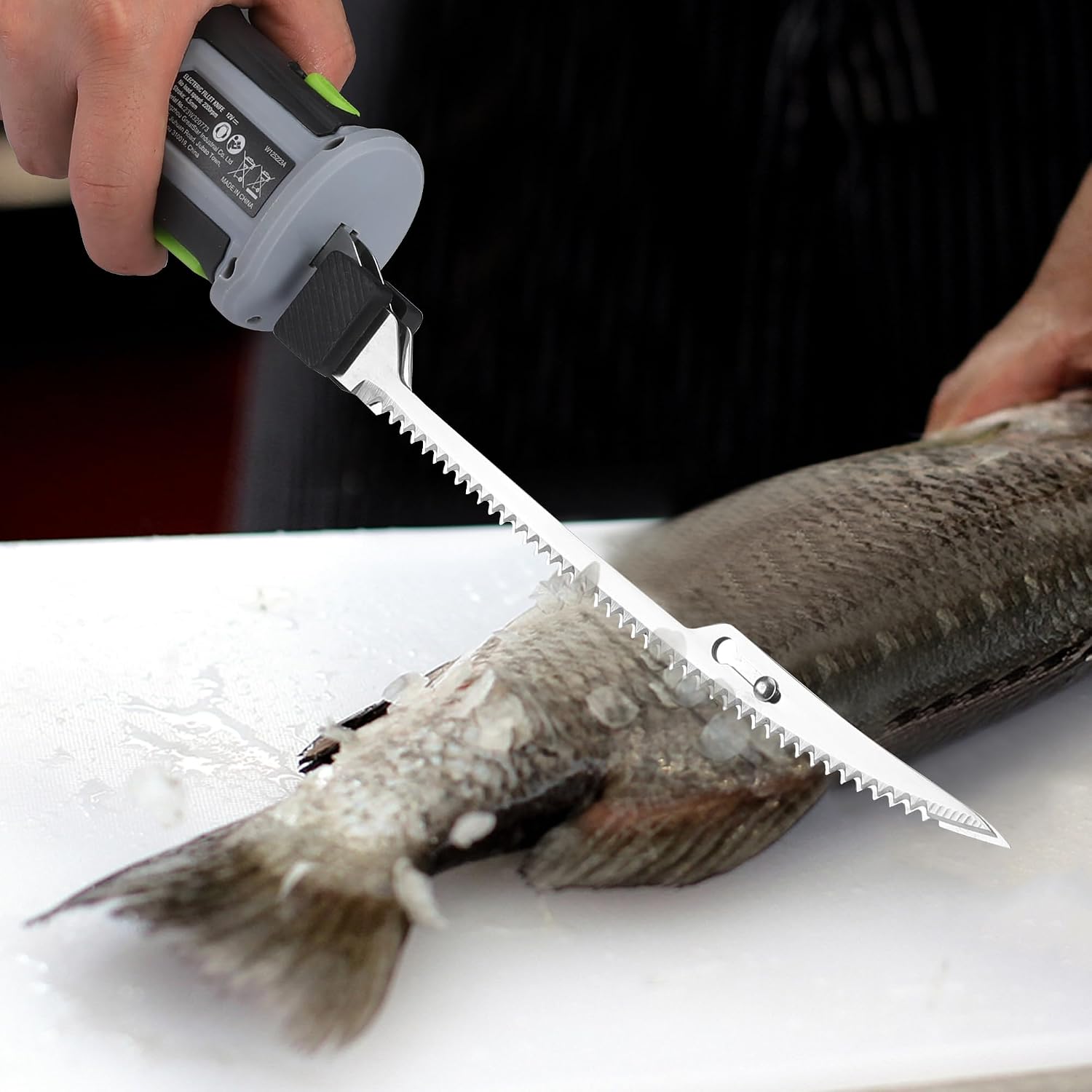 Replacement fillet blade attached to an electric knife, cutting fish