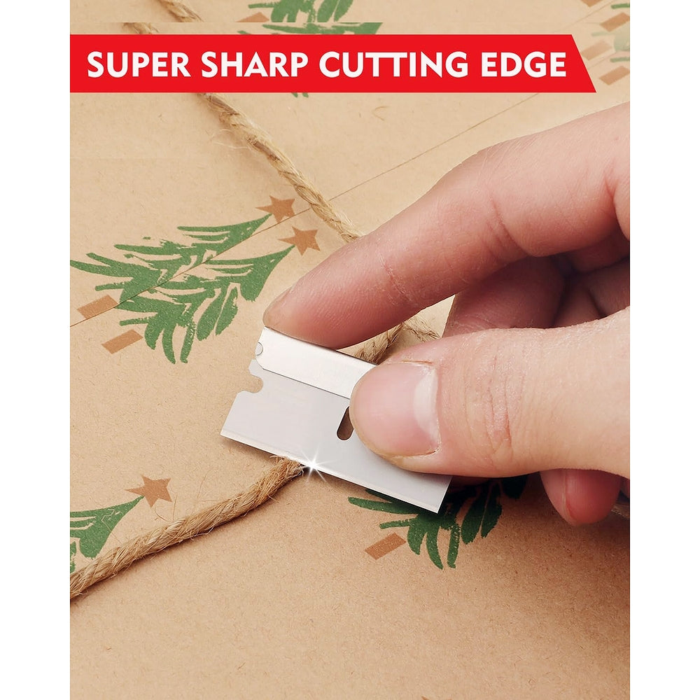 Hand holding single edge razor blade cutting twine on cardboard package