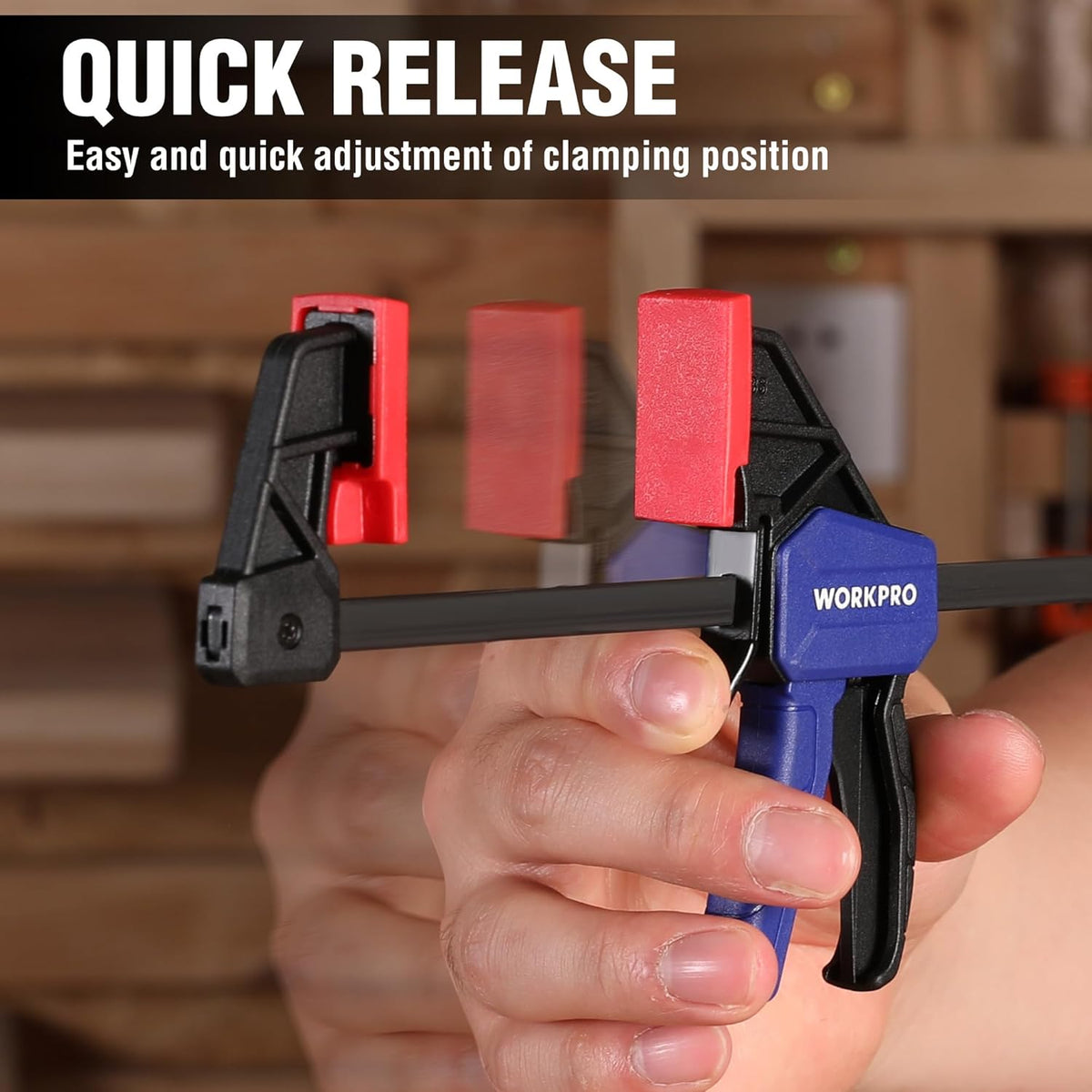 Mini bar clamp with quick-release trigger, red jaw pads on black clamp body