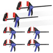 Multiple woodworking bar clamps with red pressure pads, black frames, blue grips