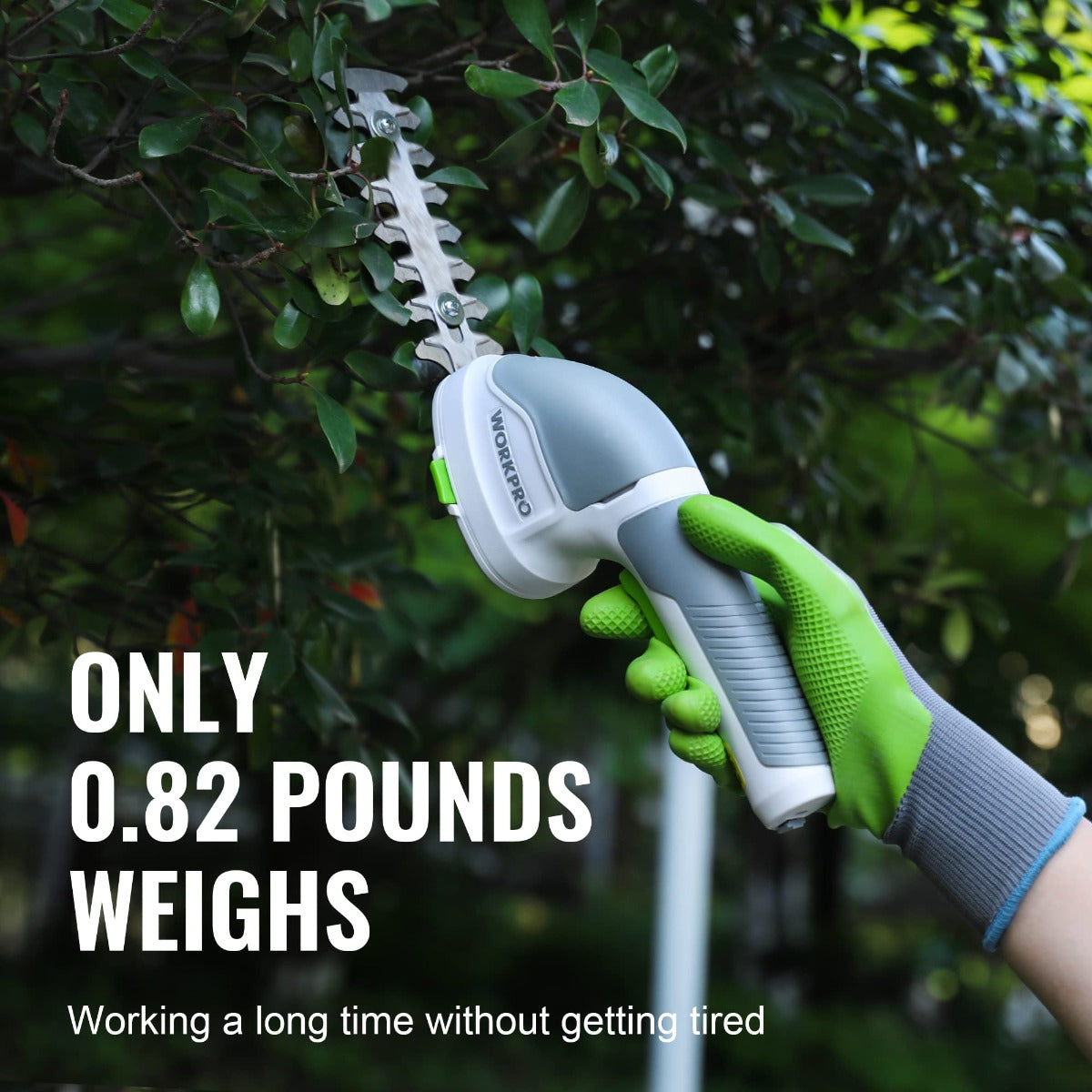 Cordless 2-in-1 shrub and grass trimmer in hand, light body and green grips on shrubs