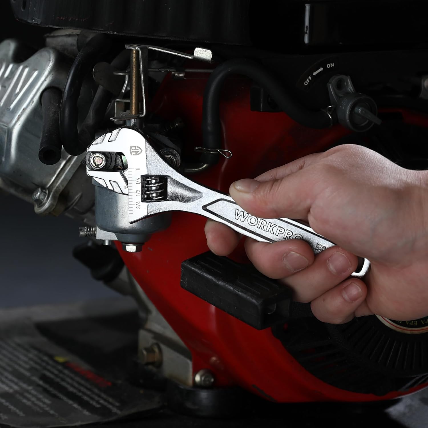 Adjustable wrench in use on engine parts with hand grip on handle