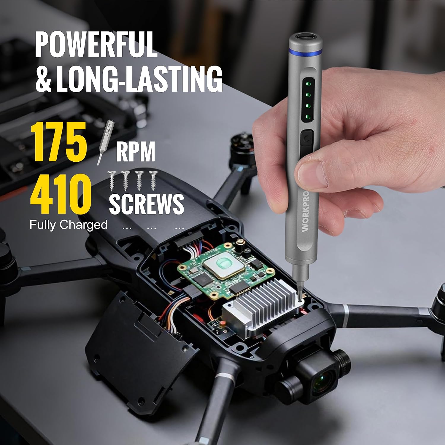 Gray precision screwdriver in hand near electronics, with LED status indicator