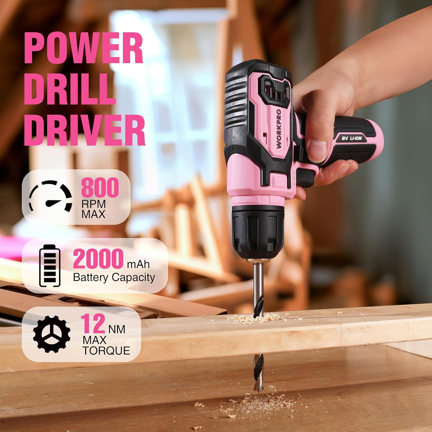 Pink 8V cordless drill driver with keyless chuck and drill bit, held in hand
