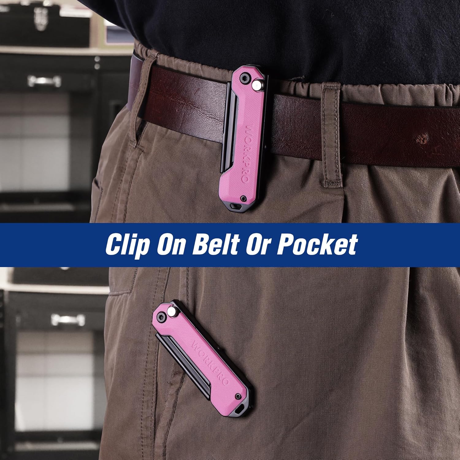 Pink folding utility knife clipped to a brown belt or pants pocket.