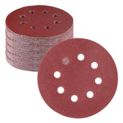 Red circular sanding disc stack with 8-hole pattern for hook-and-loop orbital sanding