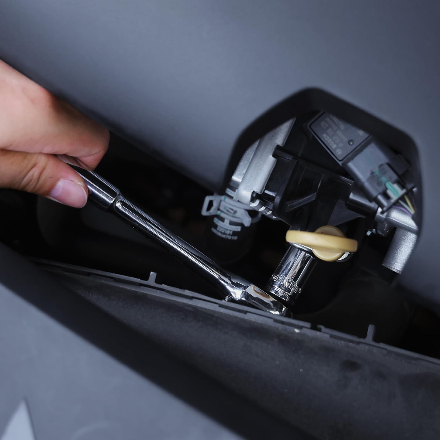 Ratchet wrench placed in a tool case compartment with socket drive visible