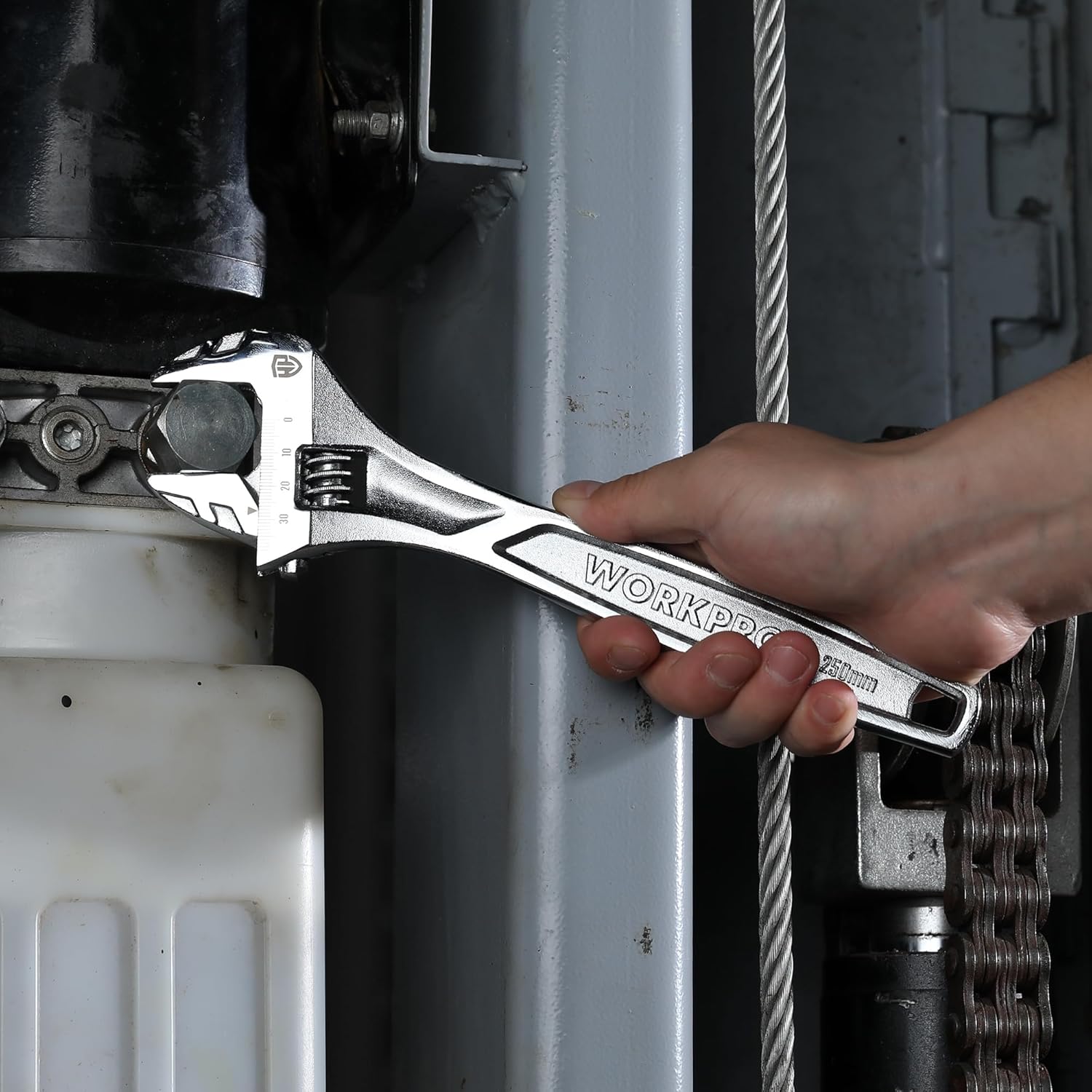 Adjustable wrench used to tighten a threaded fitting on a pipe