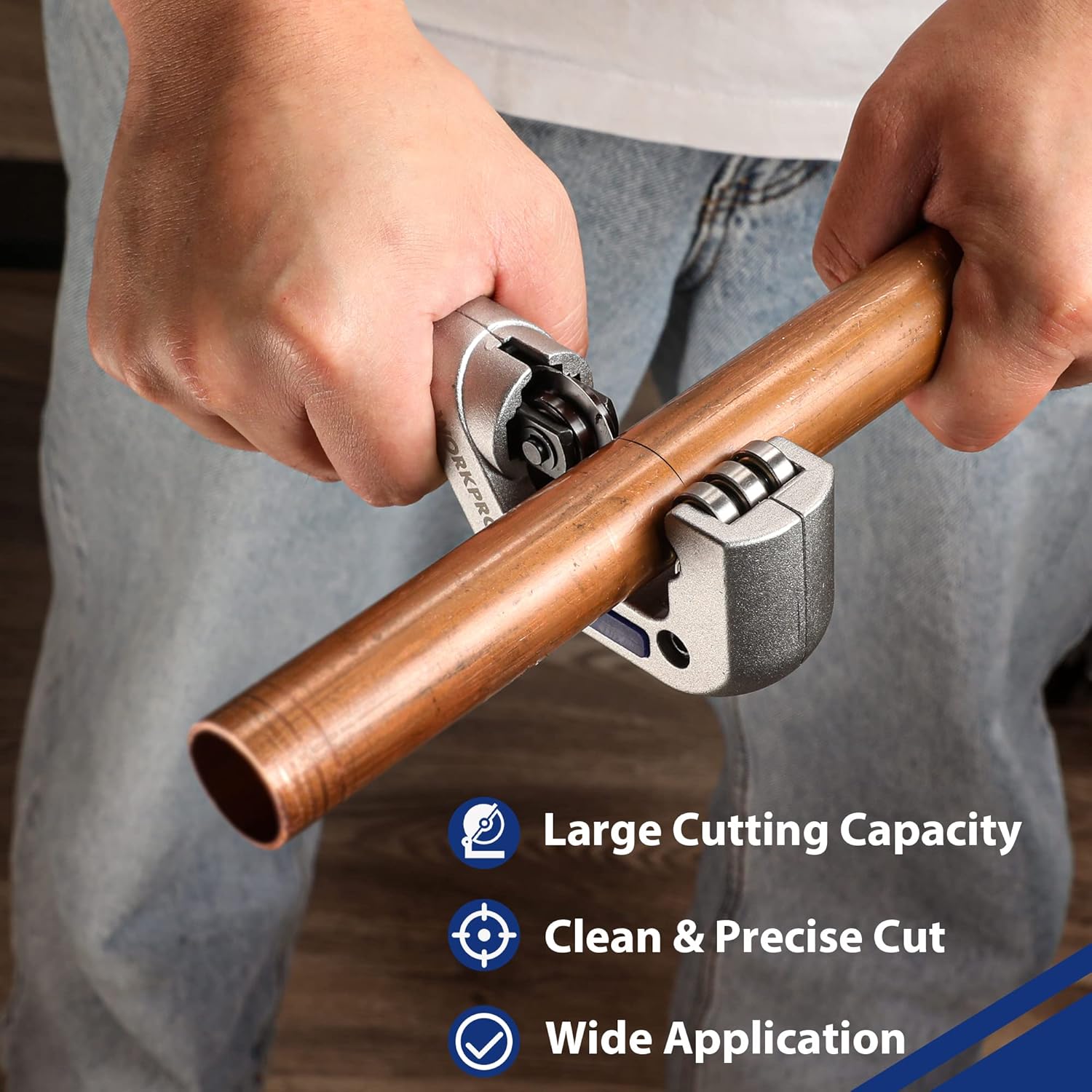 WORKPRO tubing cutter in use on a copper pipe, hands gripping the tool