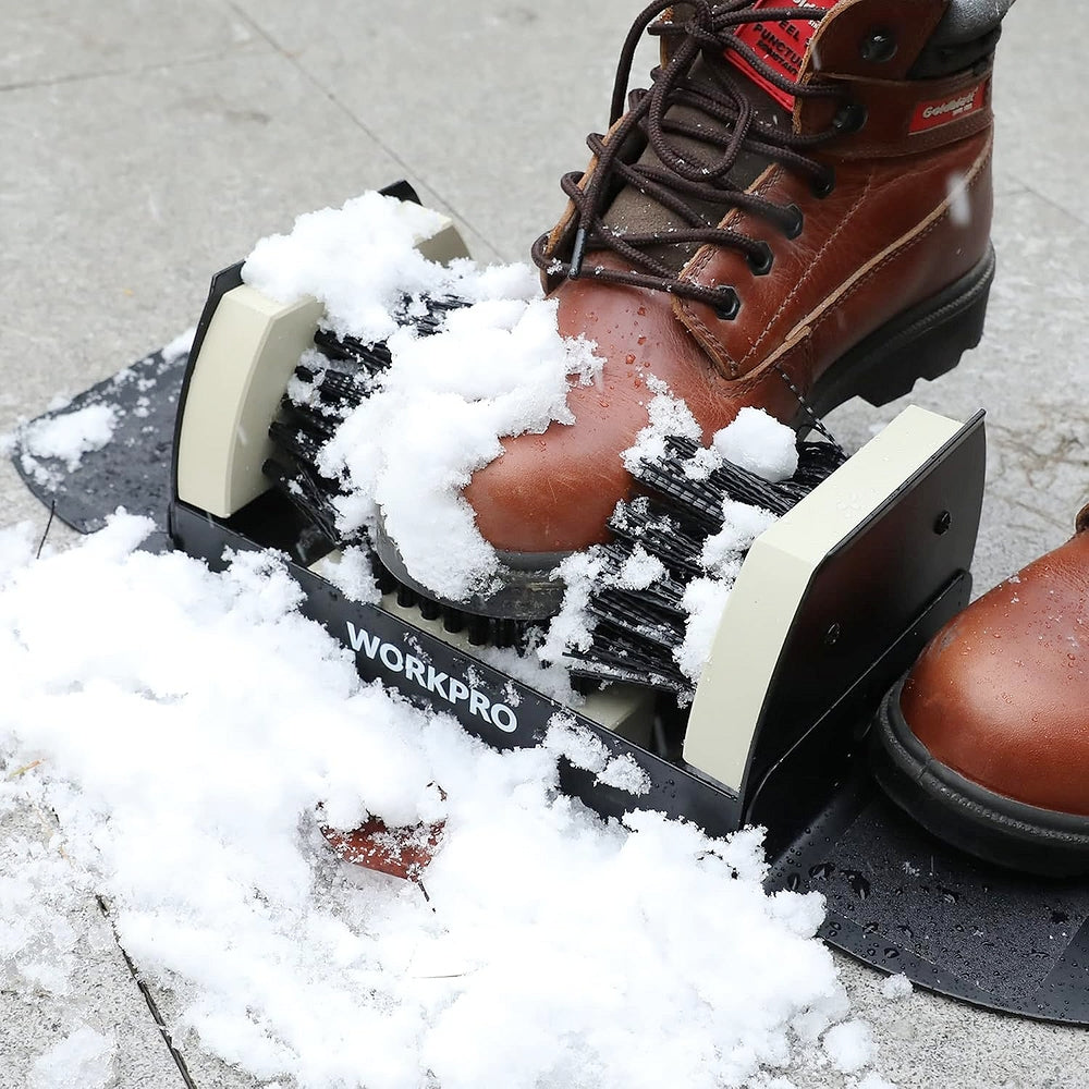 Boot scrubber brush with black bristles scraping snowy ice from brown work boots