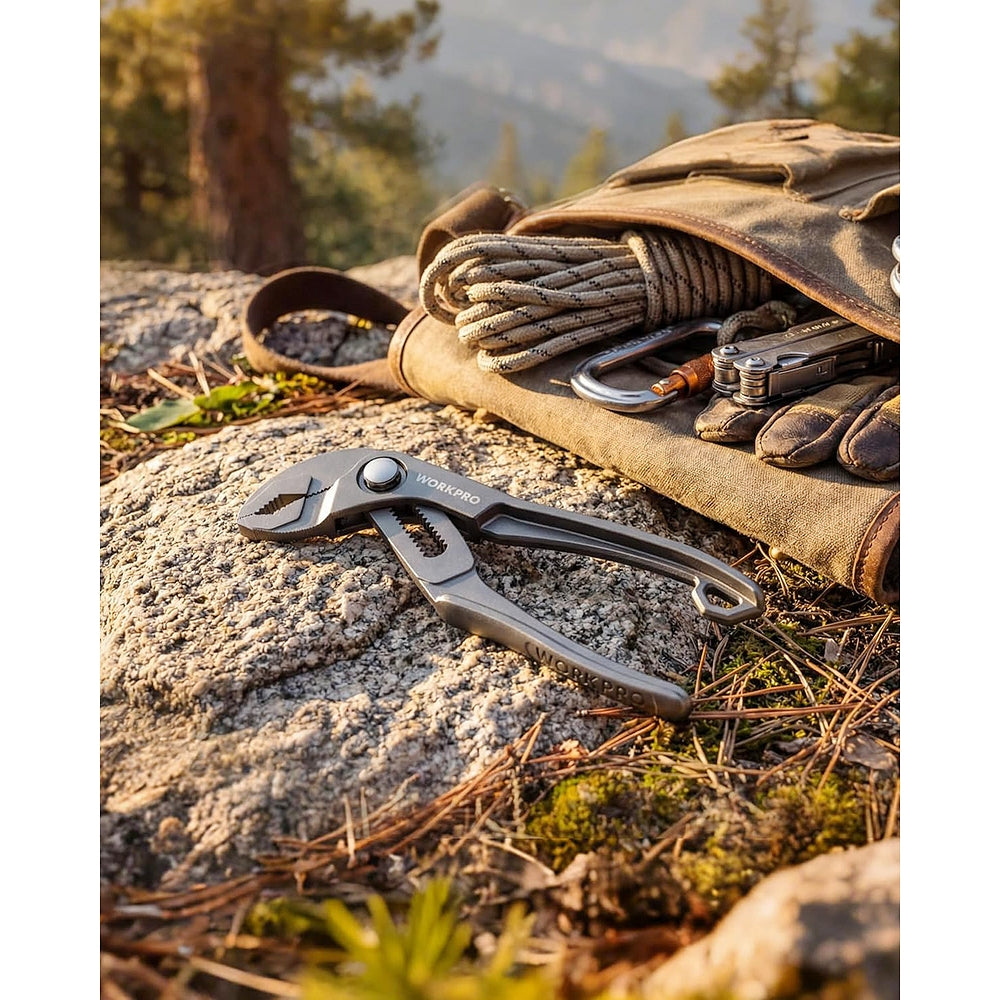 Grey WORKPRO mini water pump pliers lying on rocky ground near outdoor gear