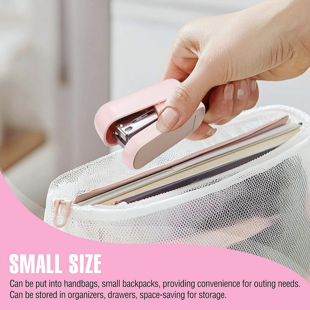 Pink mini stapler in hand, closing staples on notebook paper
